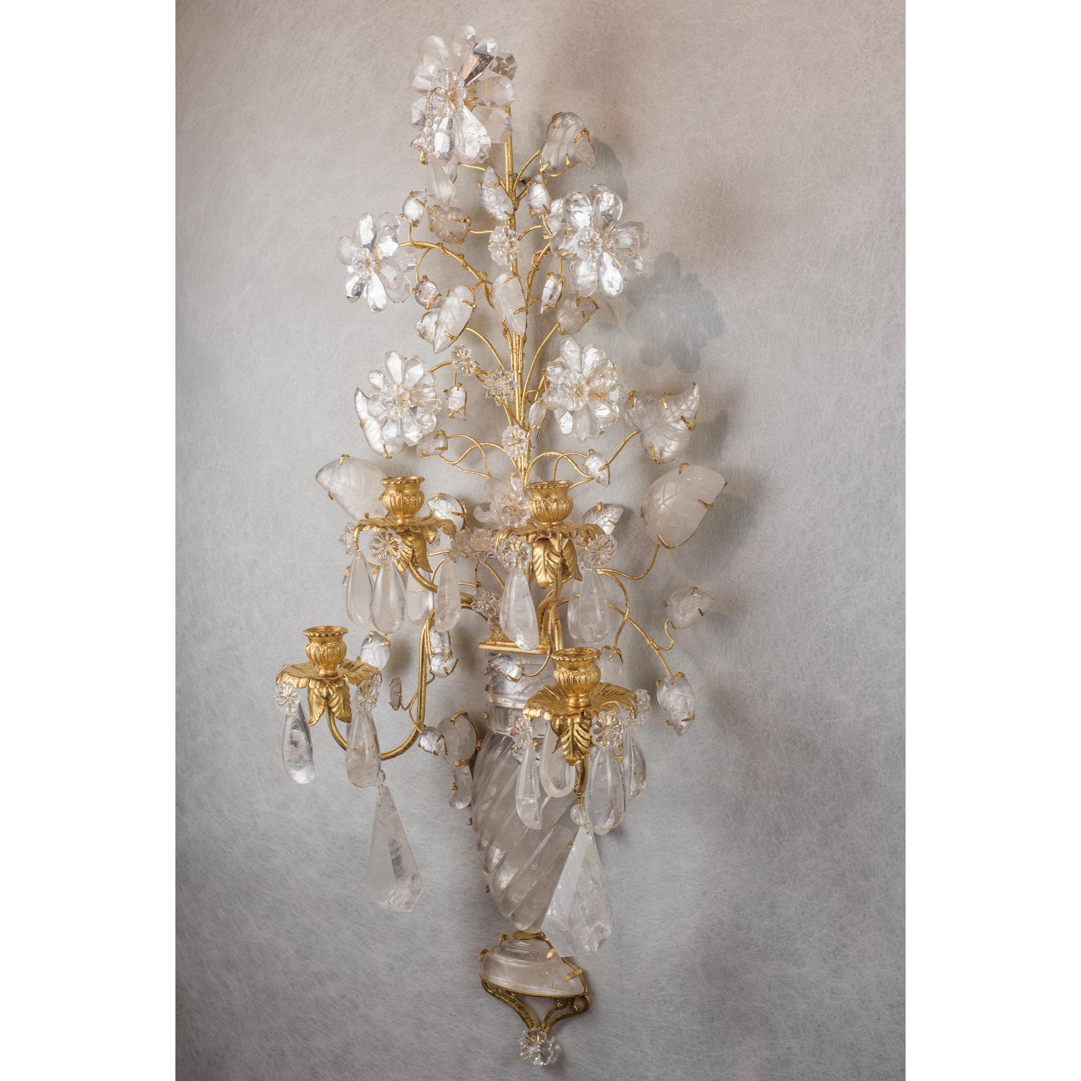 Elegant pair of French two-light gilt-metal rock crystal sconces in the form of a vase with flowers. All details are made of carved rock crystals, flowers with individual petals and leaves with individually carved stems. Light sockets are in the