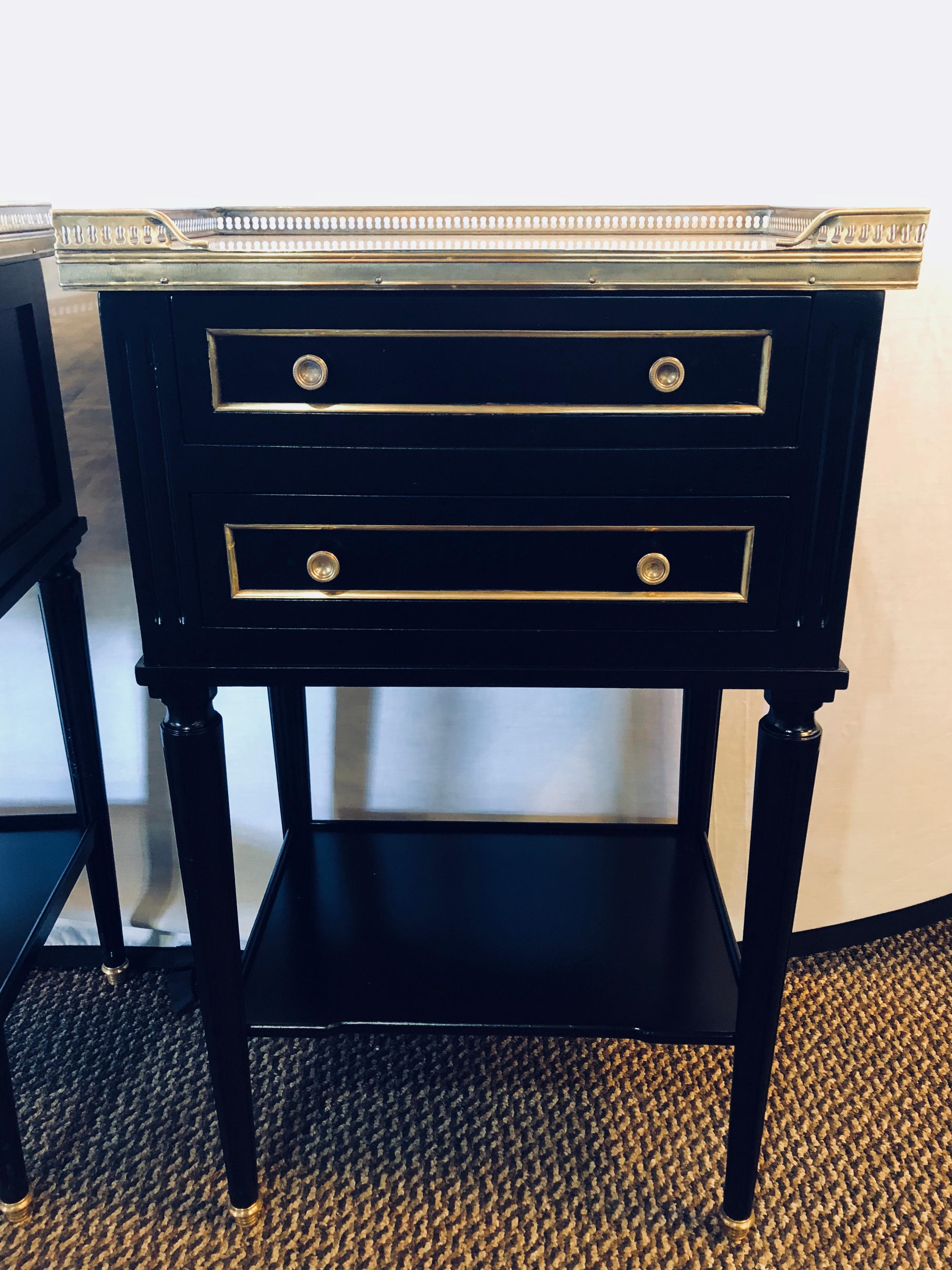 Pair of galleried marble-top ebony end tables nightstands in the manner of Jansen. Hollywood Regency at its finest are these marble tops set in a bronze galleried frame supported by a Louis XVI style case of two drawers over a single shelf. The pair
