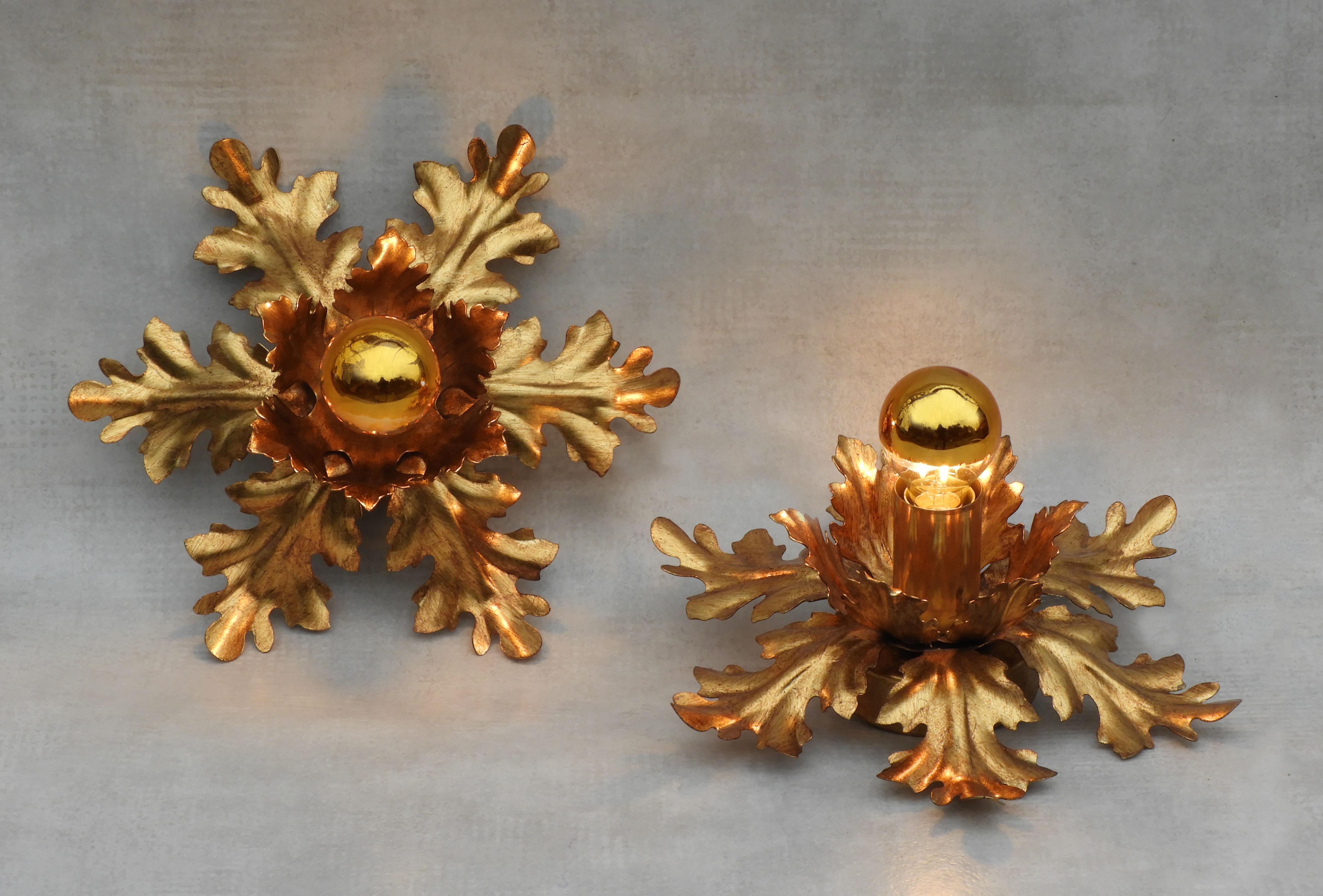 Nice pair of French flush mount ceiling lights C1980. Twelve gilded tole leaves surrounding a central bulb.  These lights can be placed as flush mount ceiling lights, wall light sconces or converted to tabletop lamps - please ask for details.  Nice