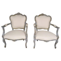 Antique Pair of French Gilt and Painted Louis XV Style Armchairs with Distressed Finish