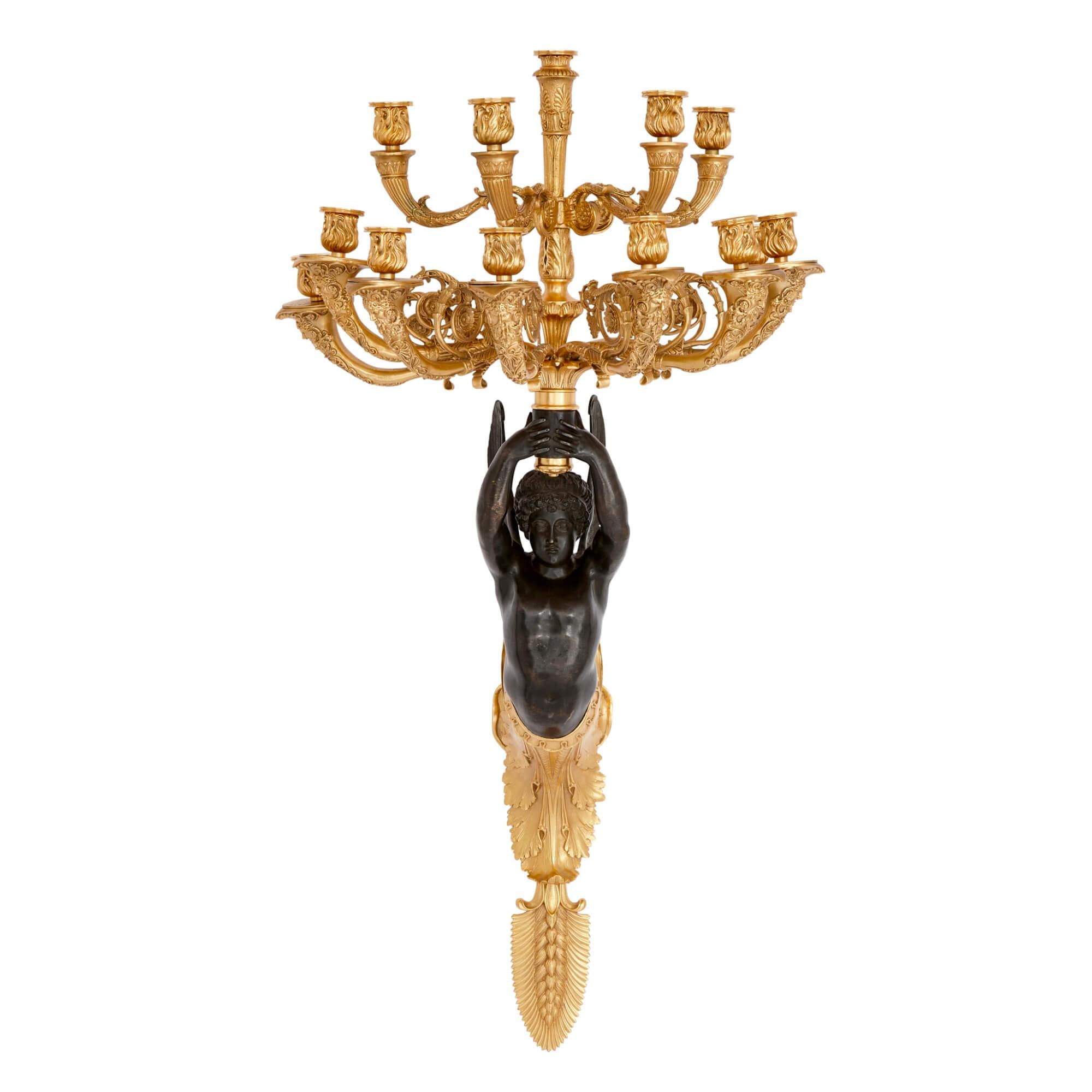 Pair of French gilt and patinated bronze wall lights
French, 20th Century
Height 103cm, width 50cm, depth 44cm

Drawing inspiration from the sophisticated Empire style, these wall lights are a brilliant showcase of artisanship. The stems, crafted