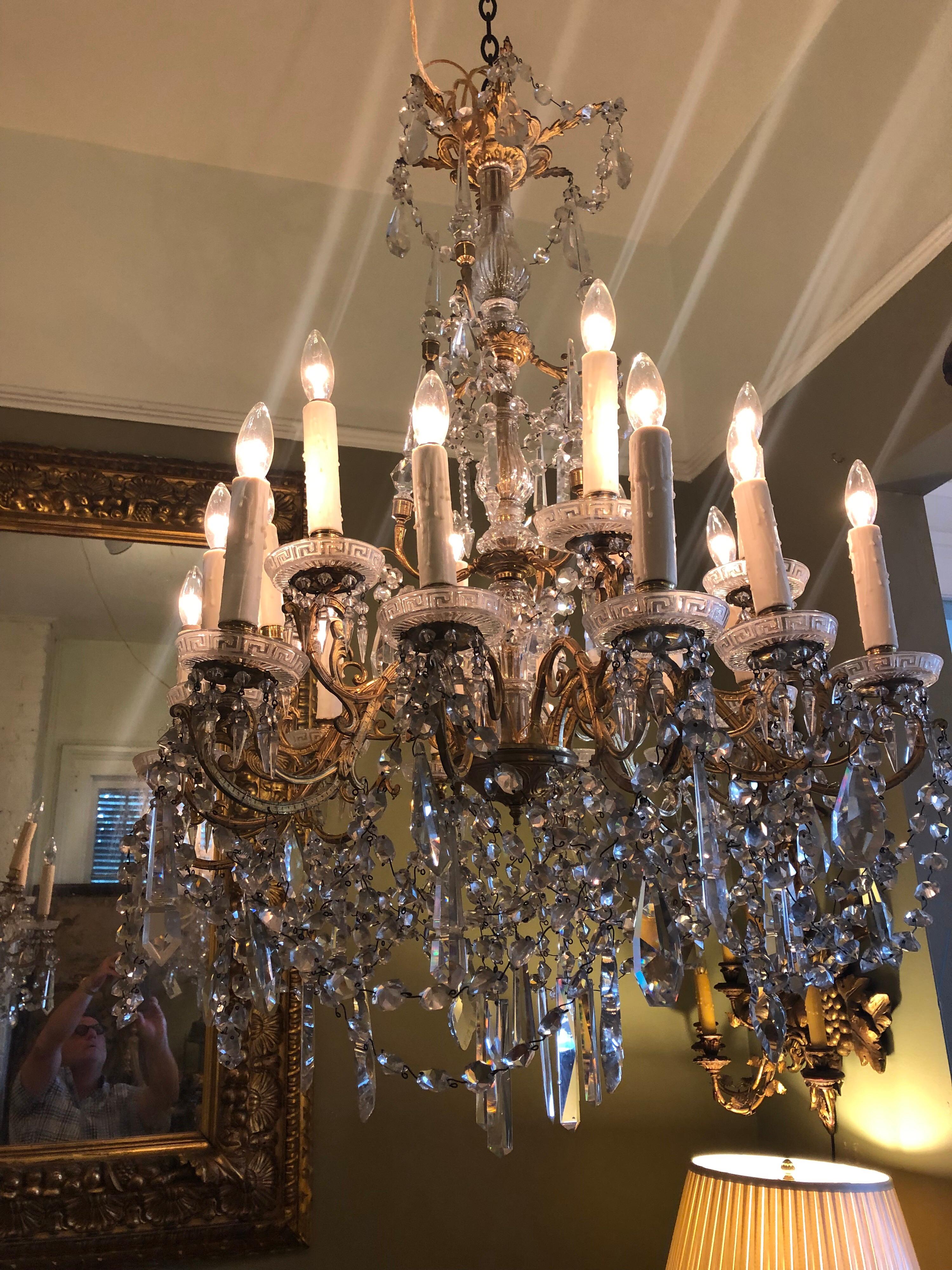 Pair of French gilt bronze and Baccarat crystal chandeliers with 18 lights each. Rewired. Baccarat crystals on gilt bronze armature.