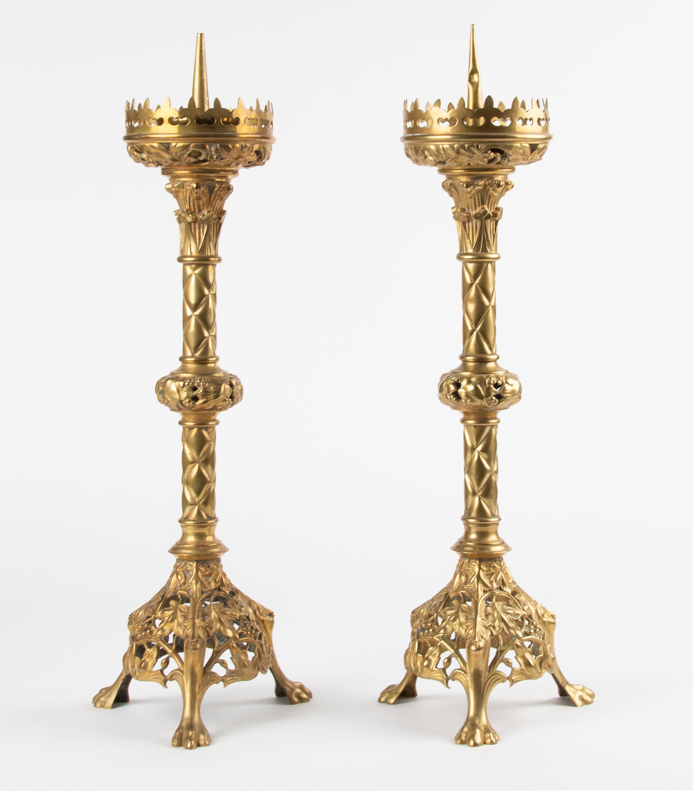 An antique and original set of two bronze casted candlesticks. These were made in France at the end of the 19th century, the Gothic Revival was popular in those days. The bronze is fire gilded, and the gilding is intact in very good condition. The