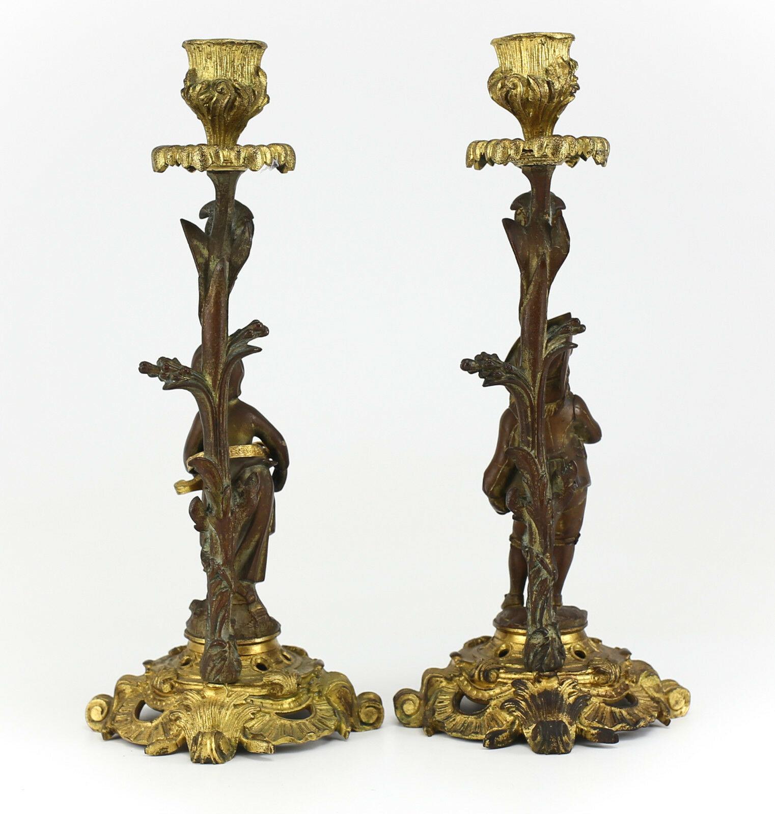 Pair of French gilt bronze candlesticks, Male & Female Musicians, 19th century 

Charming Male & Female Musician Figures w/ Flute & Mandolin Respectively attired in Colonial style Dress. Foliate scrolls compasses the base of both bases. Appearance