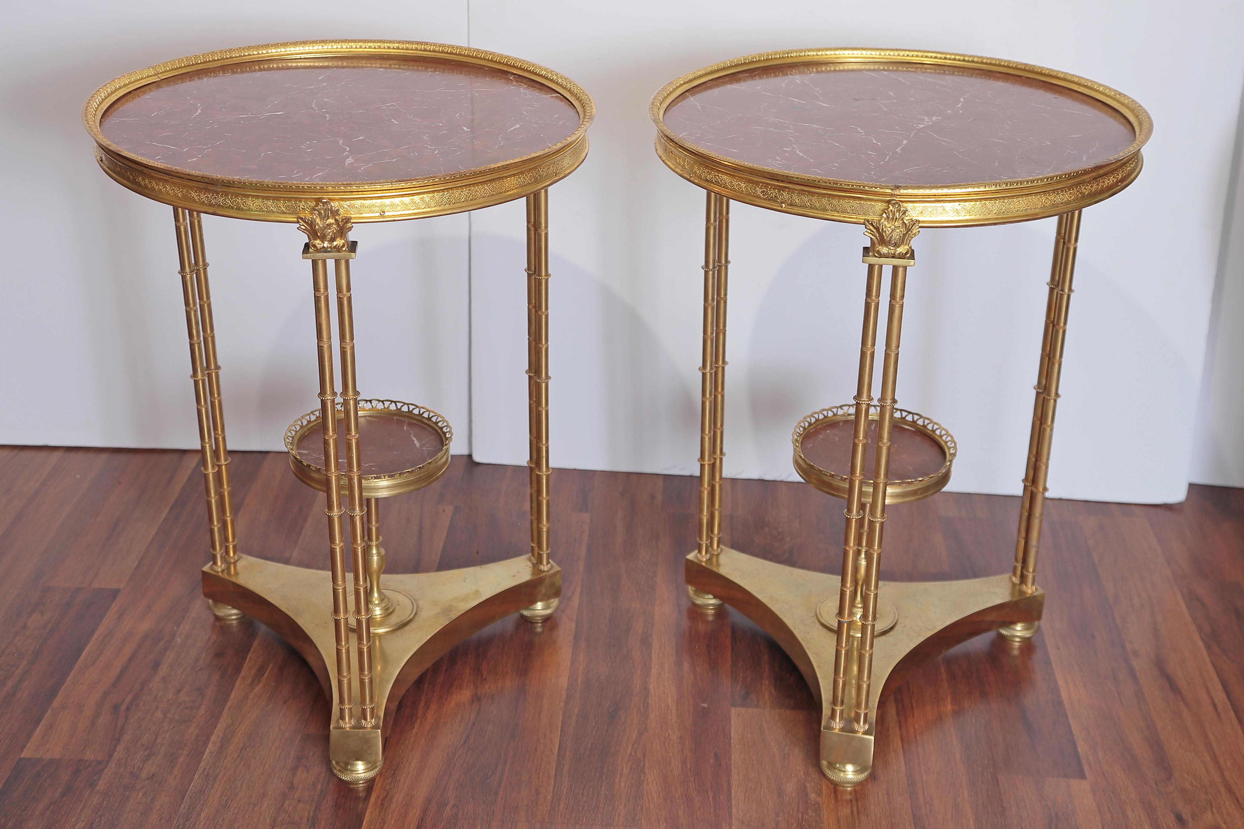 A pair of French gilt bronze Louis XVI marble-top guéridons.