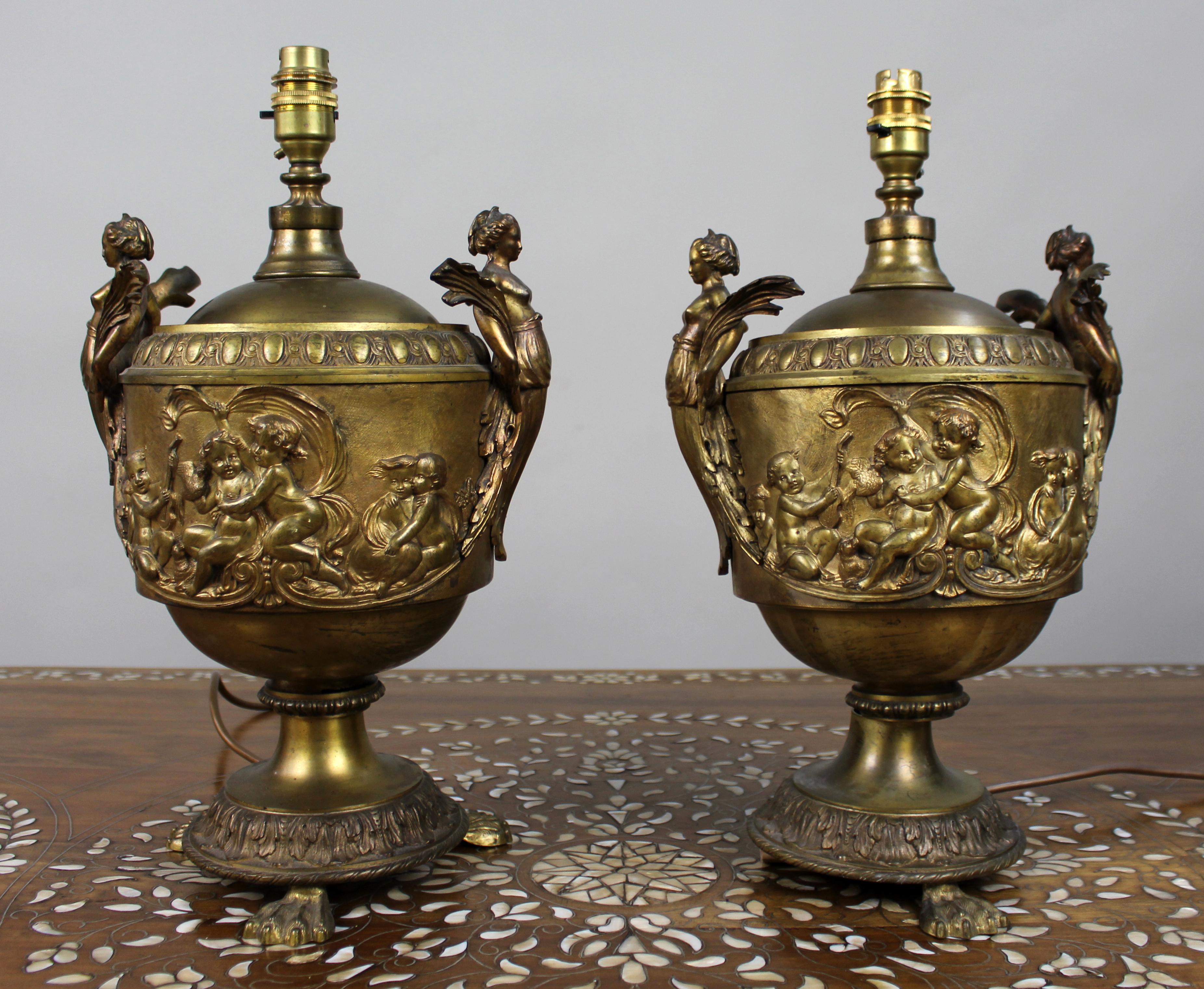 Pair of French Gilt Bronze Urn Lamps with Putti Reliefs, circa 1900

A decorative pair of French gilt bronze urns, later adapted as table lamps, dating from around 1900.

Each urn is finely cast in relief with playful scenes of putti amid scrolling
