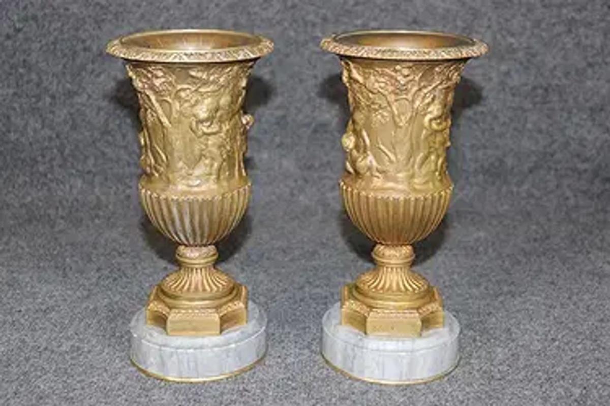 Good pair of 19th Century French gilt bronze compana vases on marble base. These vases were often used as mantel garnitures or centerpiece accents in salons and châteaux. Their classical urn shape, rich gilding, and marble grounding make them