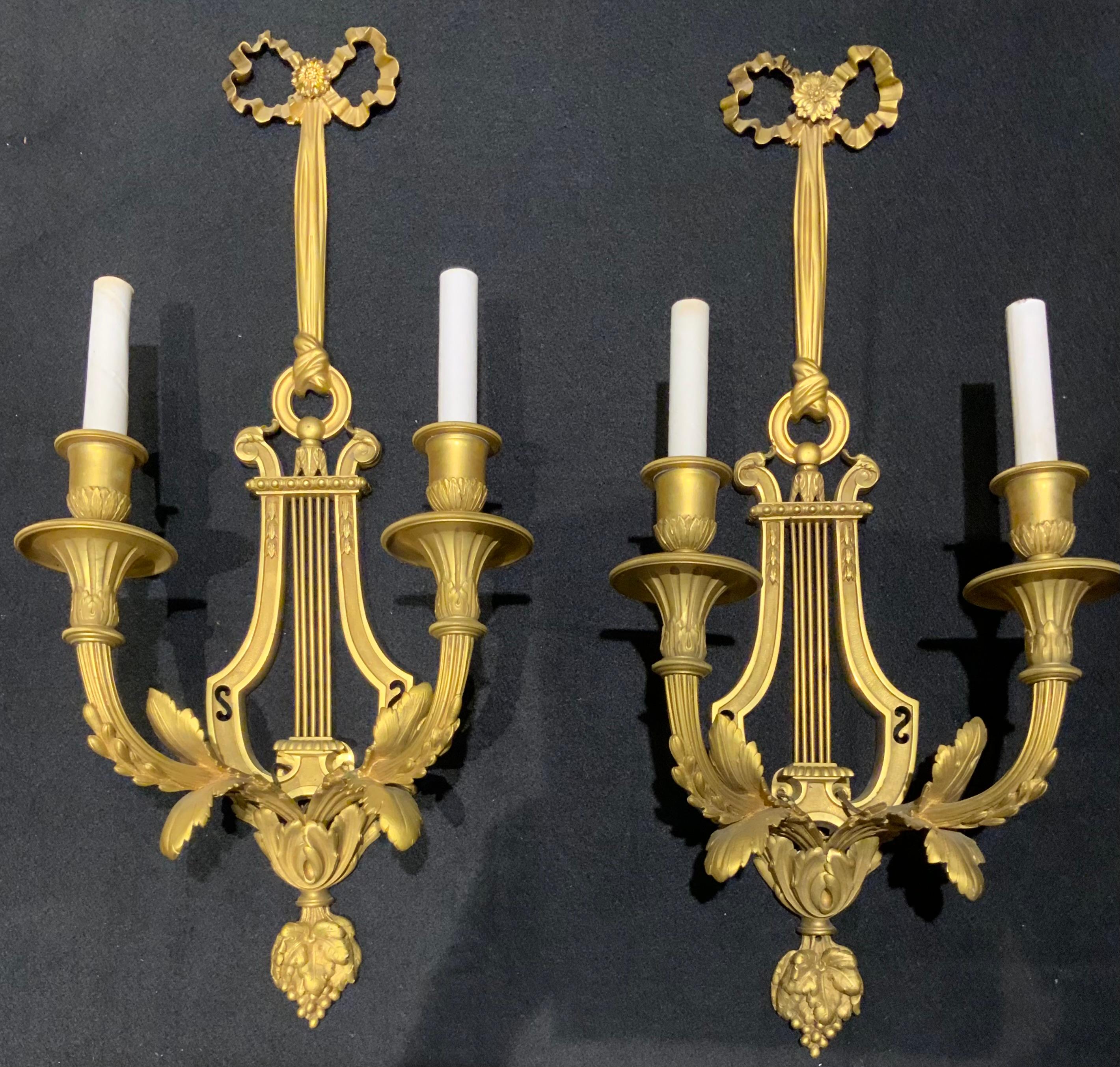 The gilding on this pair is a beautiful soft gilt gold hue,
The bronze casting is defined and sharp making this
Pair especially desirable. Each sconce has two lights
Which is already wired. The crest has a bow motif and the
Back of the sconce is in