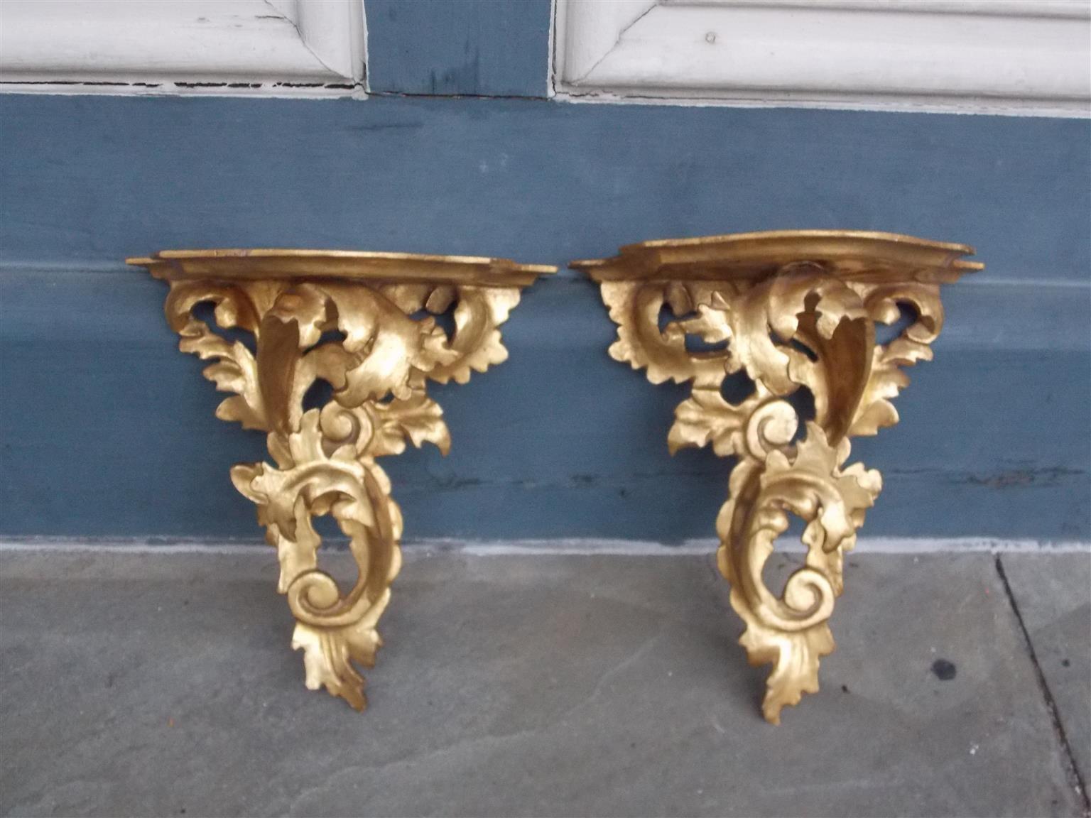 Pair of French gilt carved wood and gesso floral scrolled wall brackets with scalloped shelving, Mid-19th century.