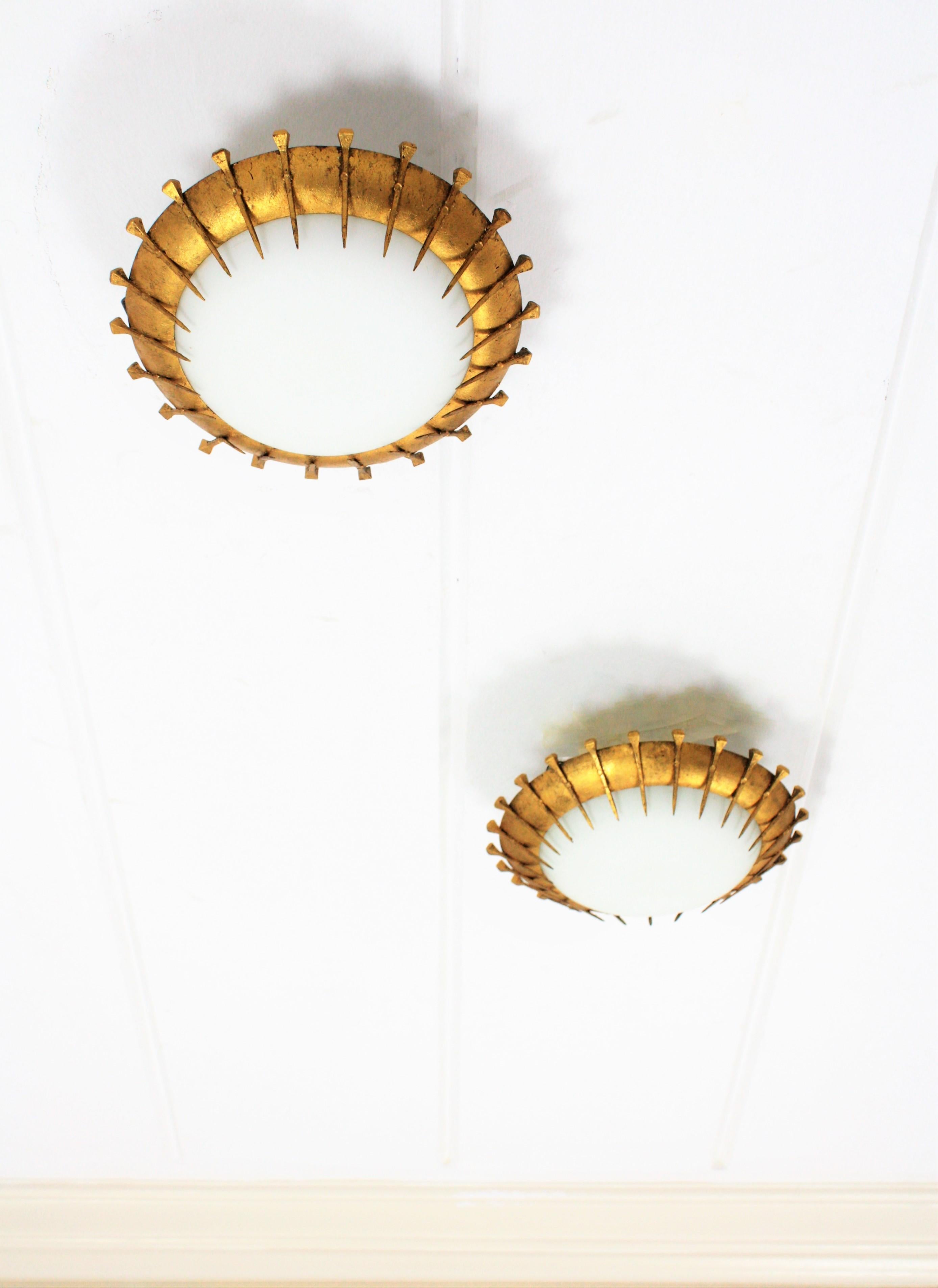 Pair of French Gilt Iron Milk Glass Sunburst Light Fixtures with Nail Accents In Good Condition For Sale In Barcelona, ES