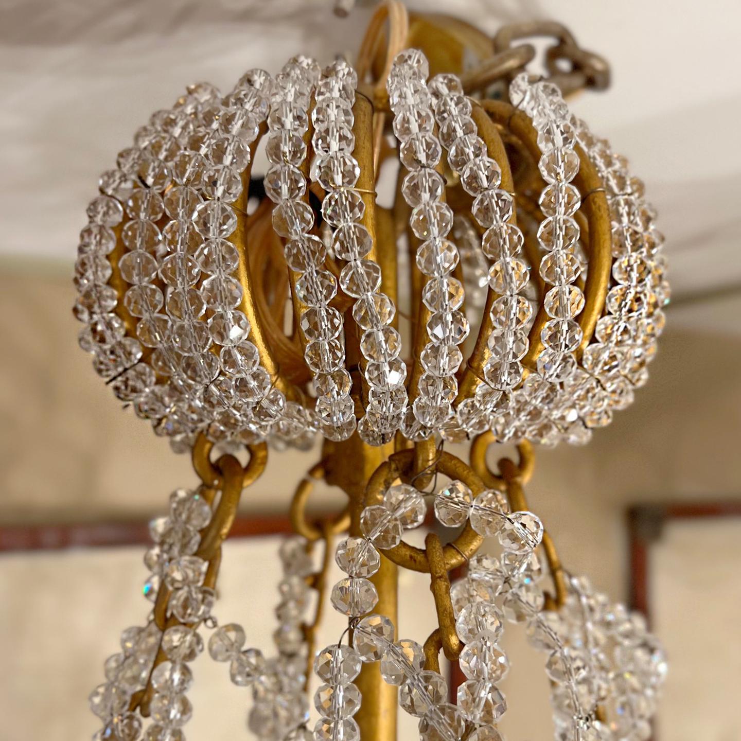 Pair of French circa 1950's gilt metal lanterns with woven crystal body, chains, canopy and five interior lights. Sold individually.

Measurements:
Height 47