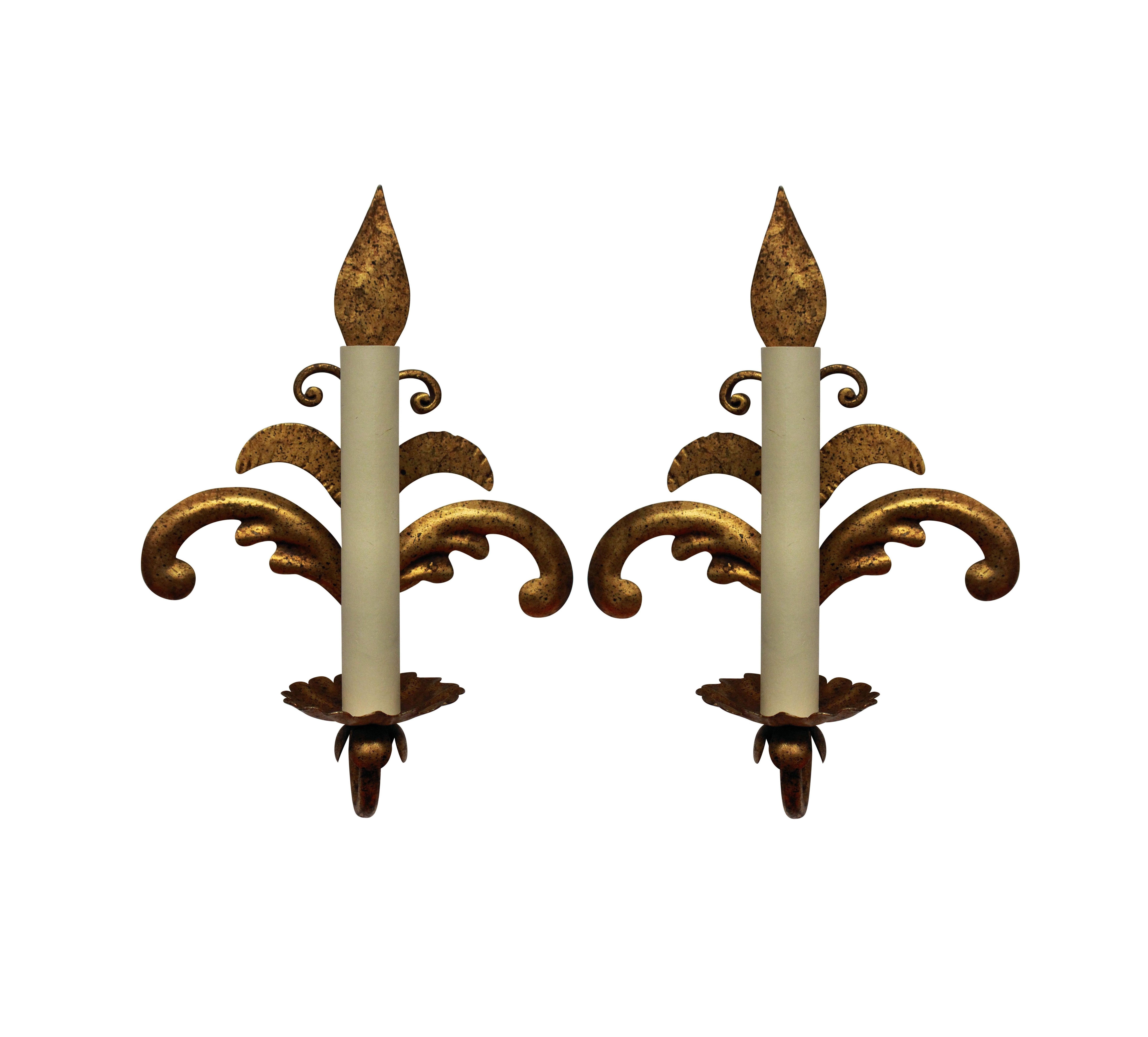 A pair of French gilt metal, single arm wall sconces.