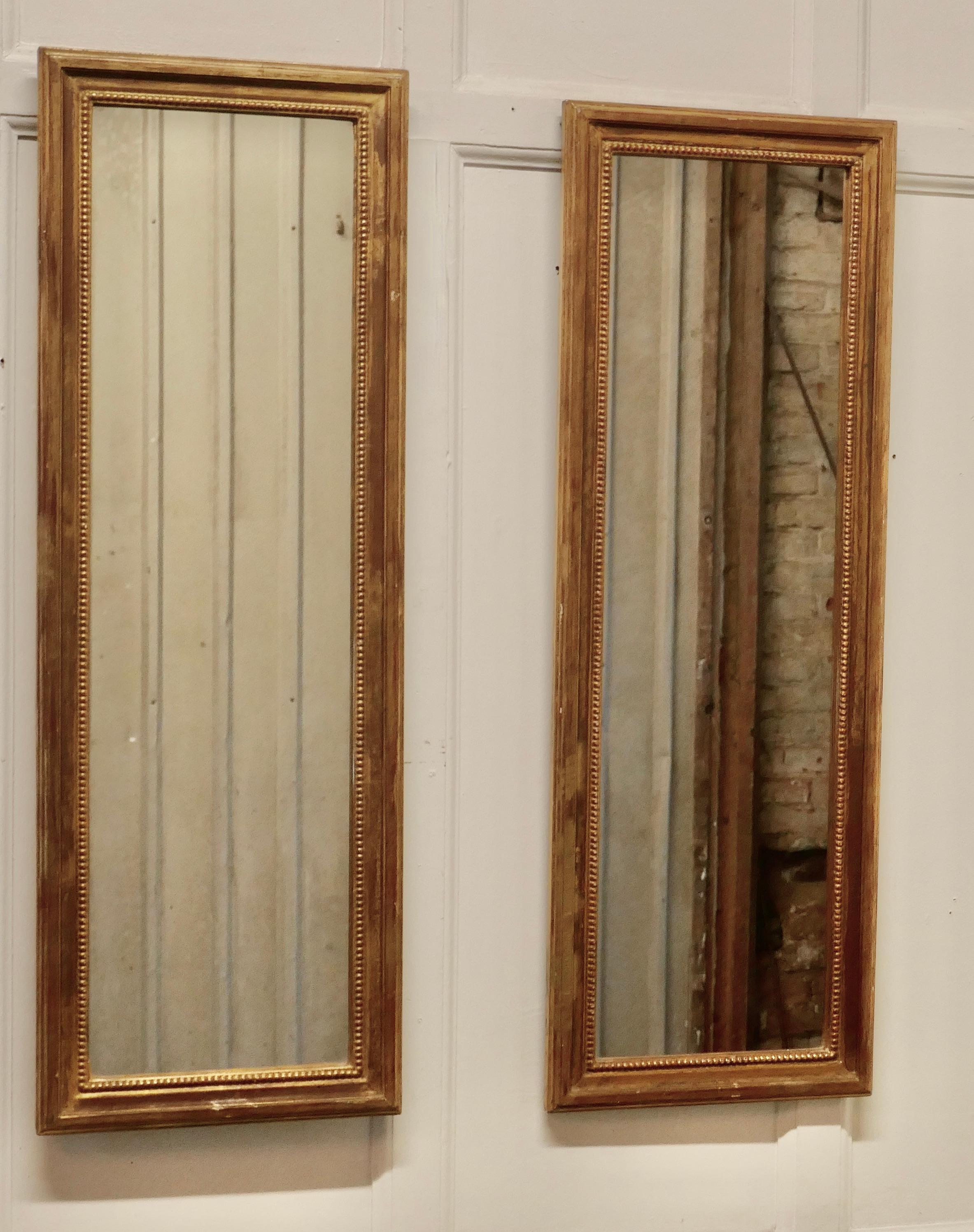 Pair of French gilt rectangular wall mirrors

The mirrors have a simple moulded 2” wide gold frames 
The glasses are is in good condition and they have heavy wooden backs 
A good mirror will always add light and elegance to a room and a pair is