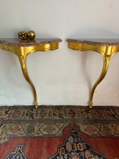 Pair of French gilt wood and marble consoles