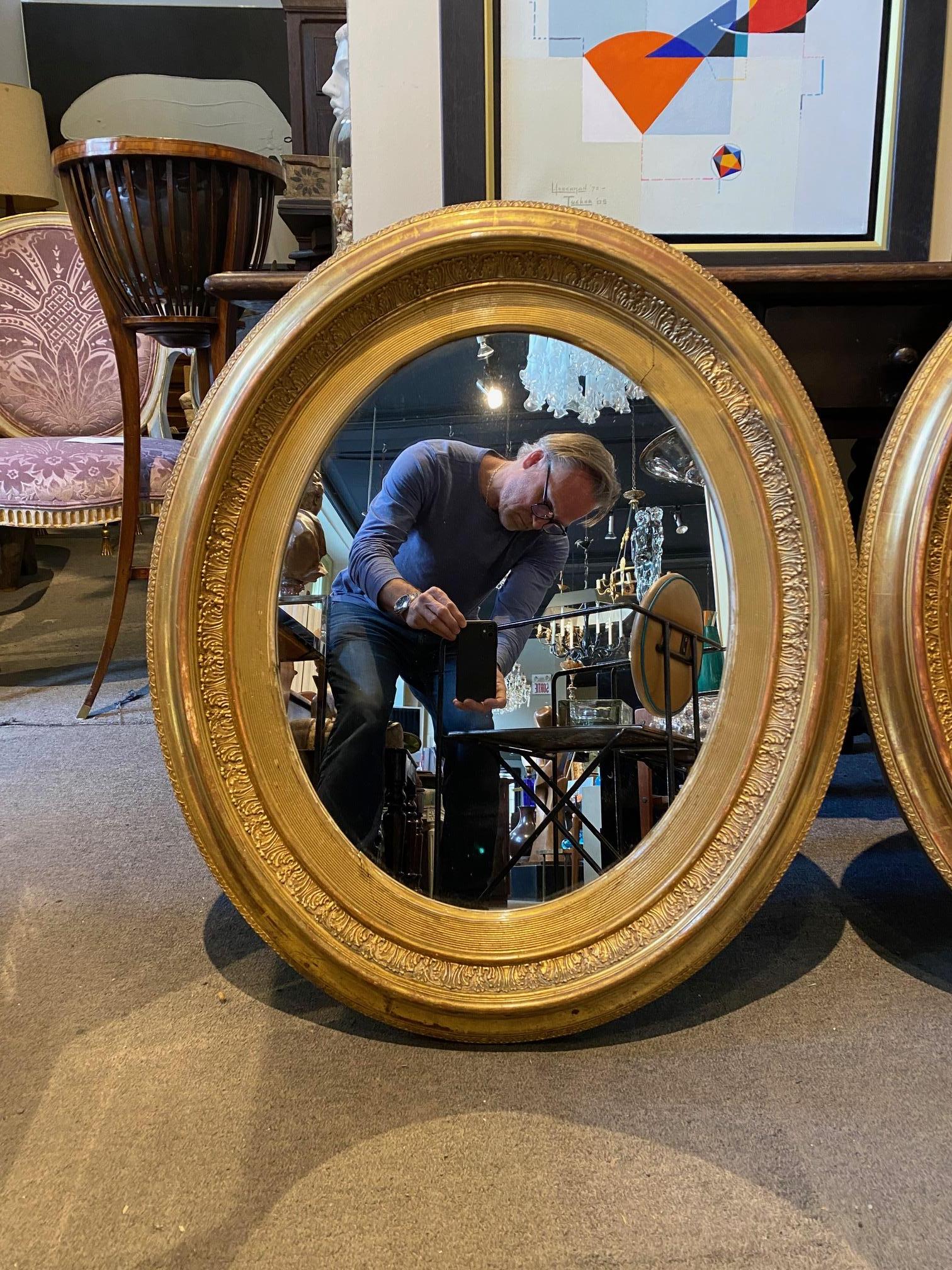 Pair of French giltwood Napoleon III oval mirrors.
