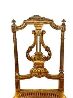 Paire de chaises à dossier en forme de lyre en bois doré et rotin, période Second Empire français