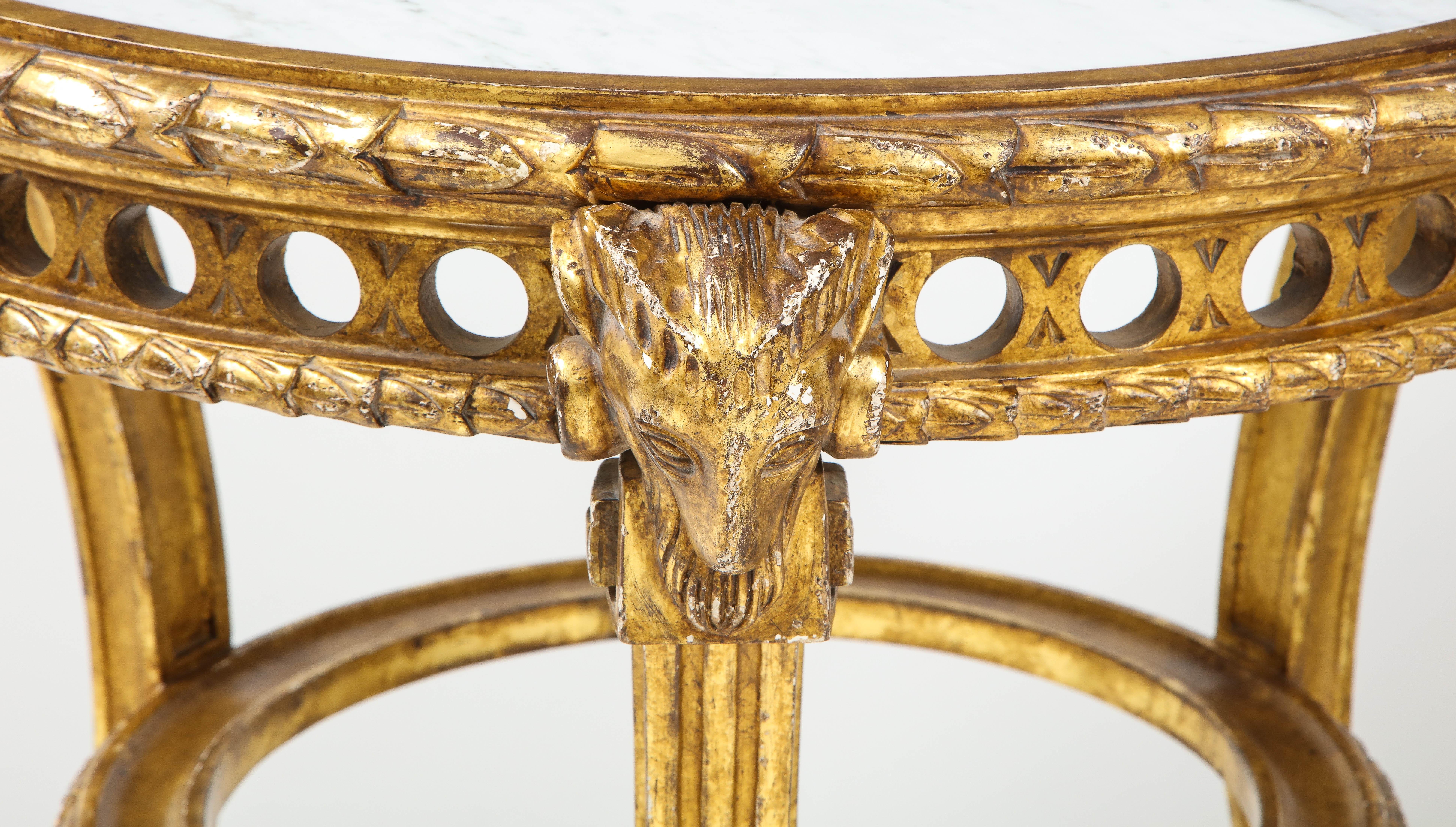 A duo with star power, these 19th century guéridon tables feature beautiful carved details throughout, including rams' heads on each side, a leaf motif surrounding the marble top, a circle design on the apron, fluted lags and hoof feet with a Greek