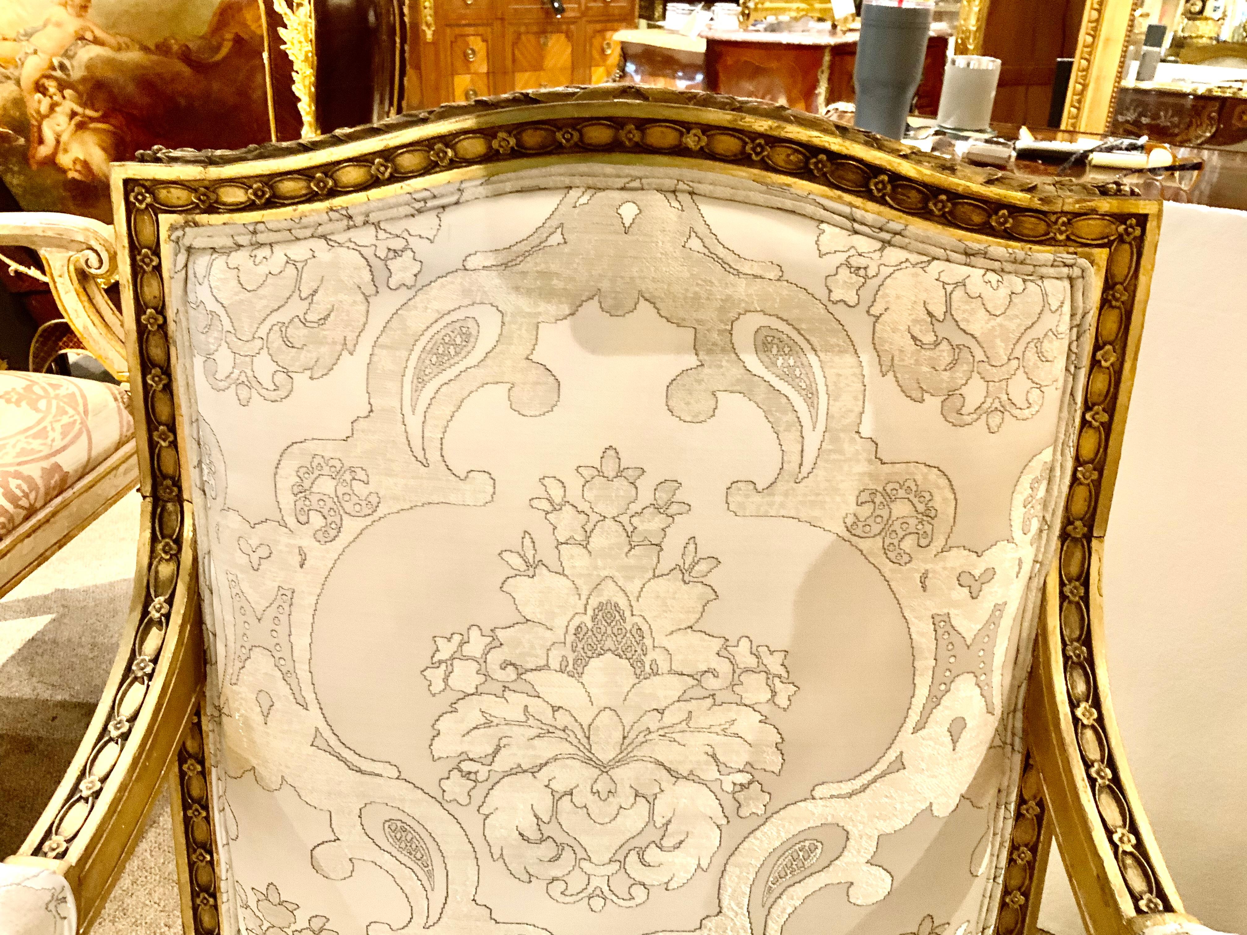 French louis XVI-styling make this pair special with a beautiful tapered
And squared leg. The chair back is gracefully shaped in a slightly
Oval raised back. The fabric is in rich hues which has shades of white,
Gray and silver. The upholstery is