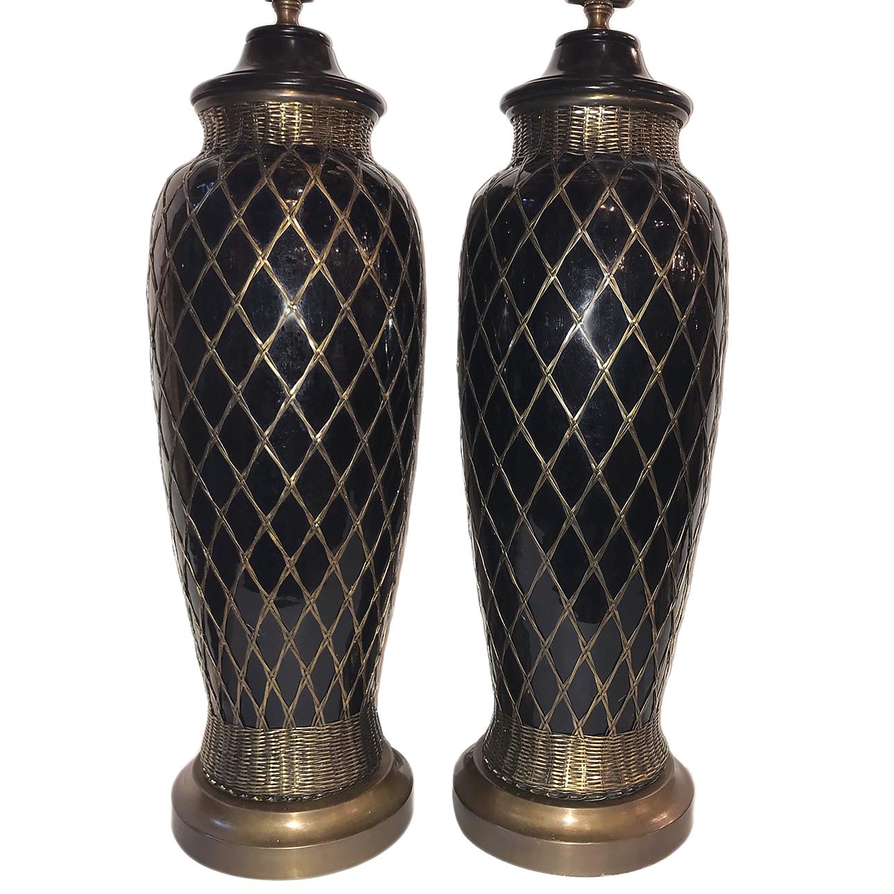 Pair of circa 1940s French black glazed porcelain table lamps with faux bamboo metal weaving on body.

Measurements:
Height of body: 20.5