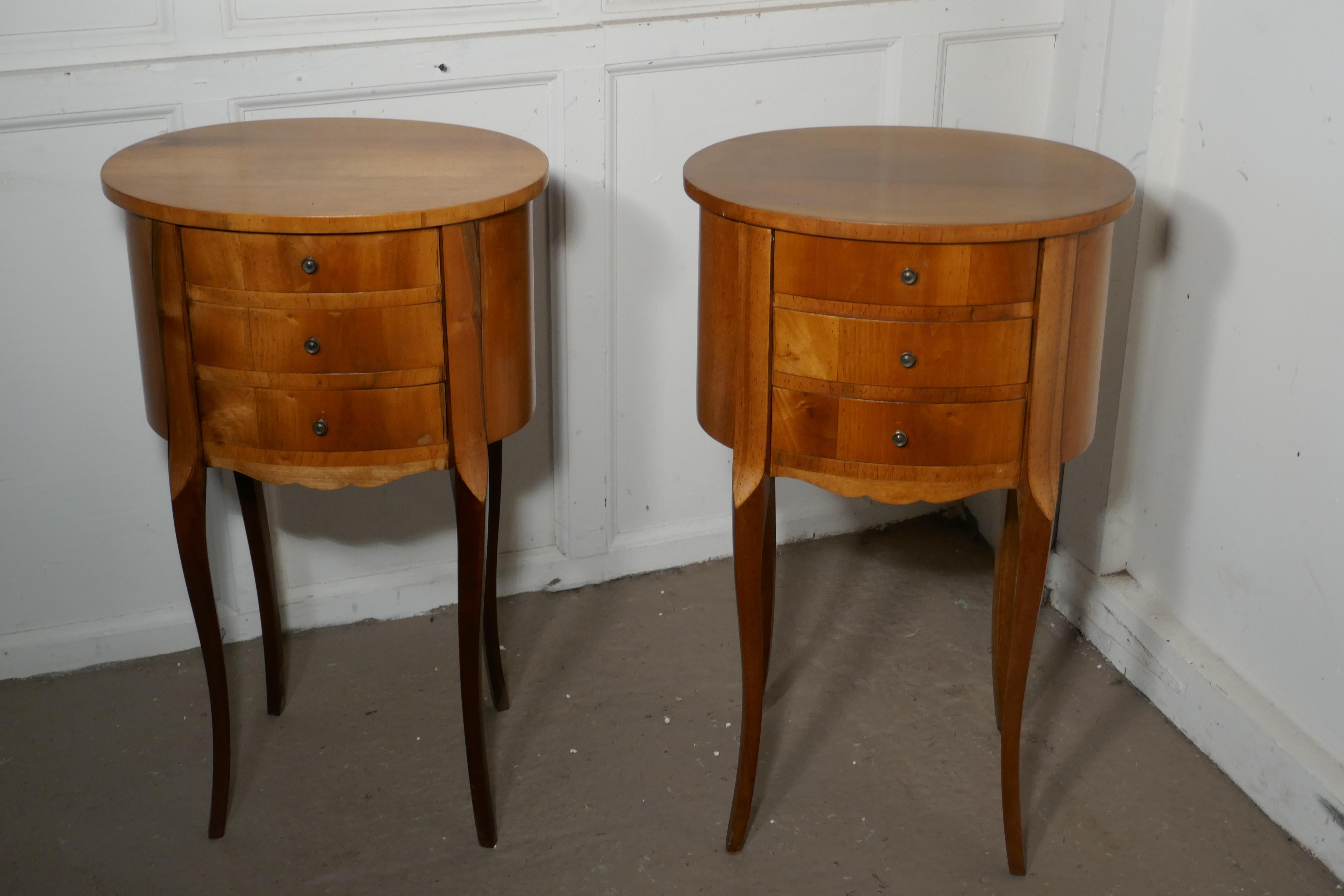 Pair of French golden cherry oval bedside cabinets

This is a pretty pair of cabinets or chevets, they are made in golden cherry and have an oval shape, they each have 3 drawers to the front and stand on splayed legs

The cabinets are in good