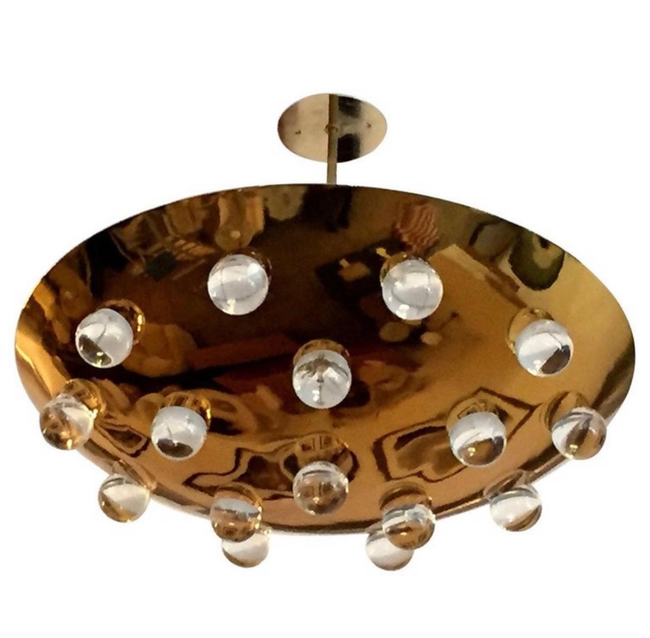 A wonderful pair of 1960s French golden solid polished  brass round disc fixture with 16 solid glass orbs. Five-light sources which emit light downward through the glass as well as up toward the ceiling. The ceiling pole can be lengthened or