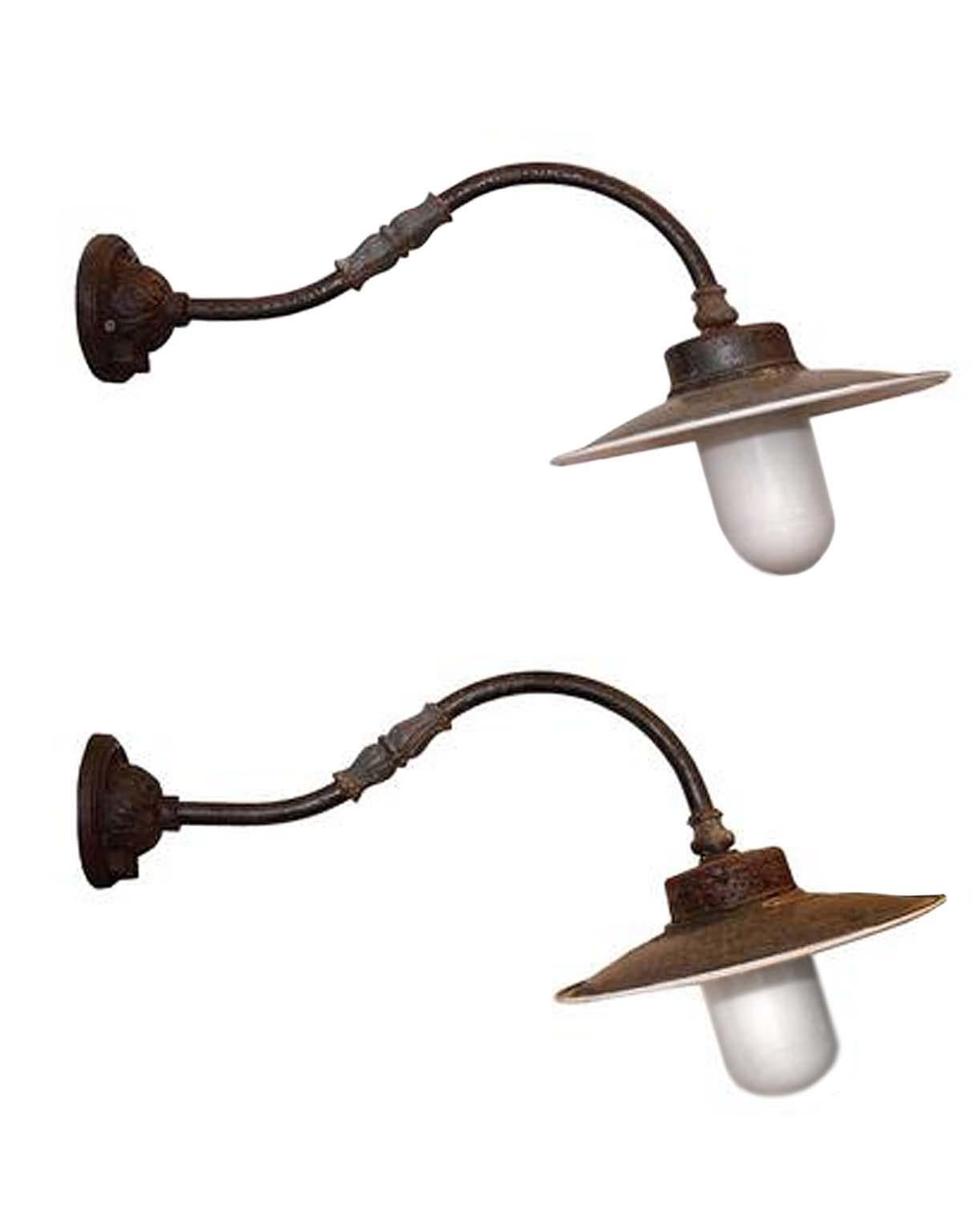 This is a pair of original antique goose neck sconces. The glass is original and they have been rewired. They are stunning. The hoods are porcelain on the underside and the measurements listed are from the wall out. They are made from cast iron,