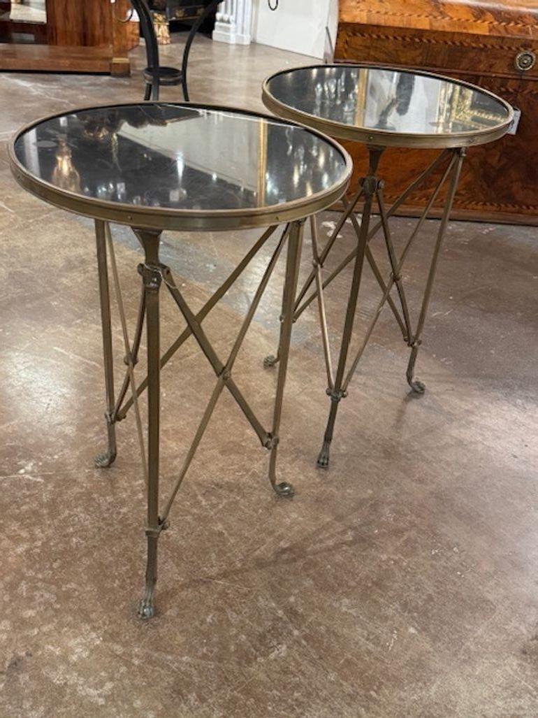 Pair of French Directoire' style bronze and black granite side tables. French Directoire–style bronze and black granite side tables offer timeless symmetry, rich finishes, and sculptural charm.17w x26.5h 