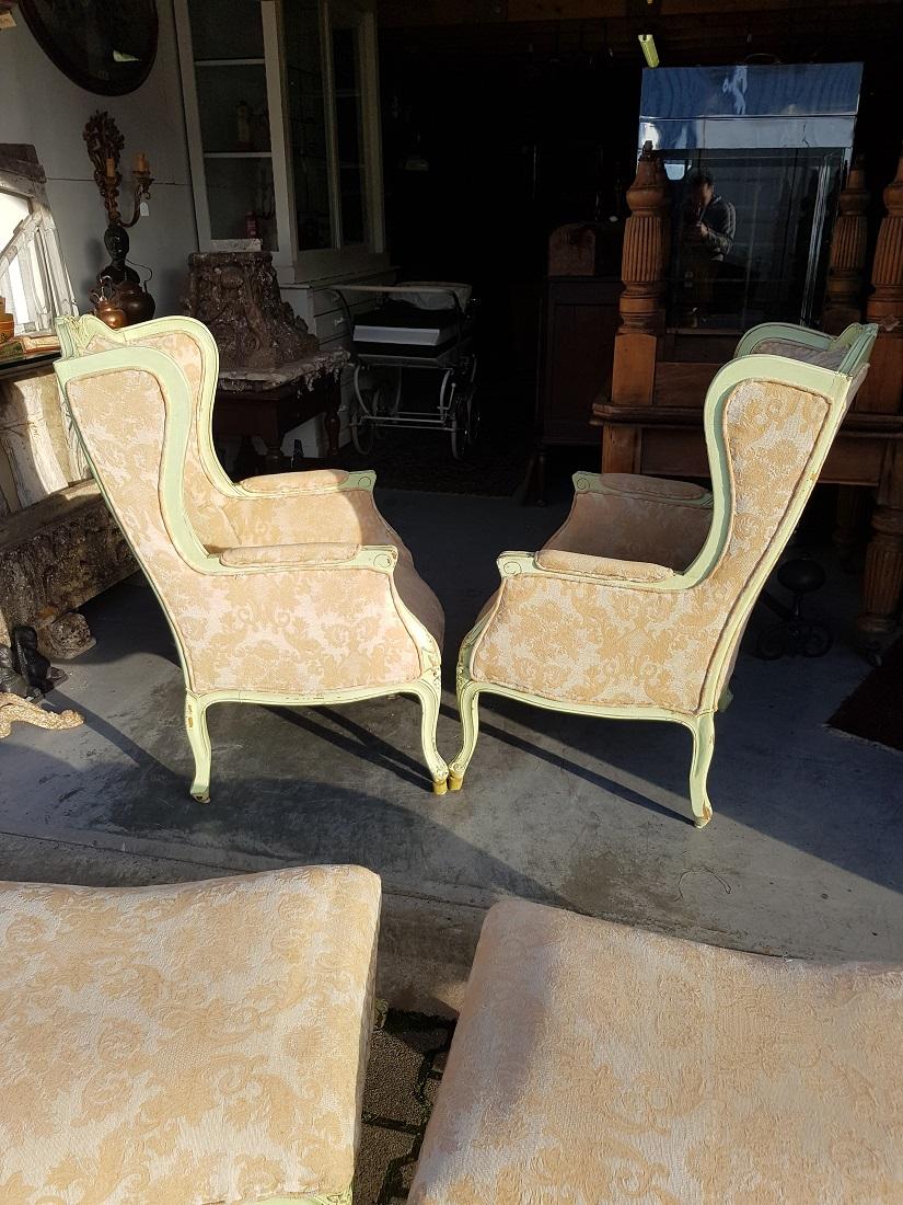 Pair of French Green Painted Wingback Chairs with Footstools, Late 20th Century For Sale 1