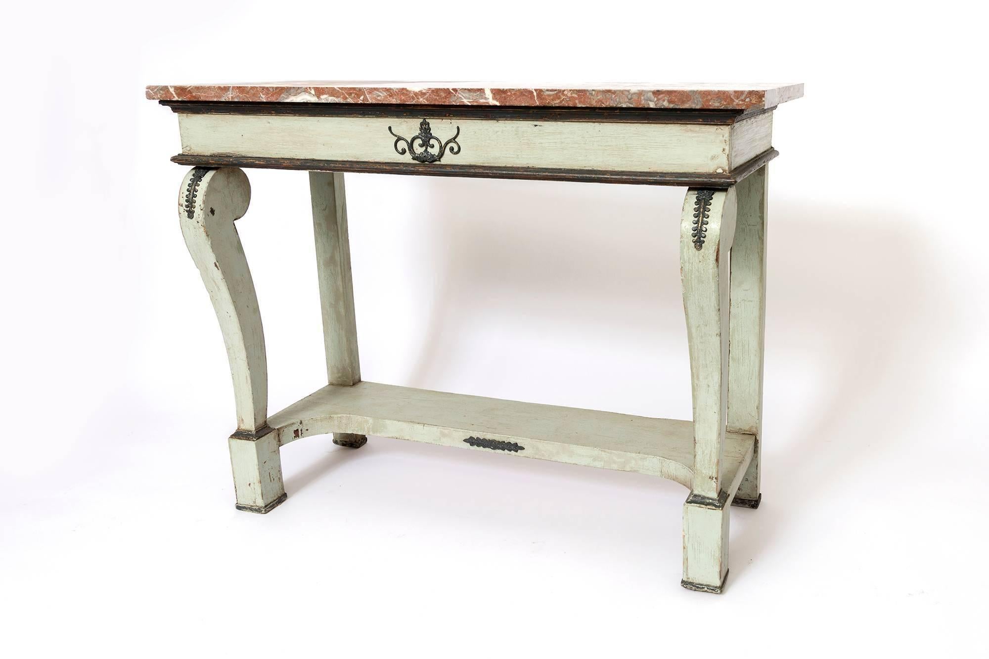 A beautiful pair of carved French console tables in a light greenish grey with marble tops. Stud details and black painted trim.