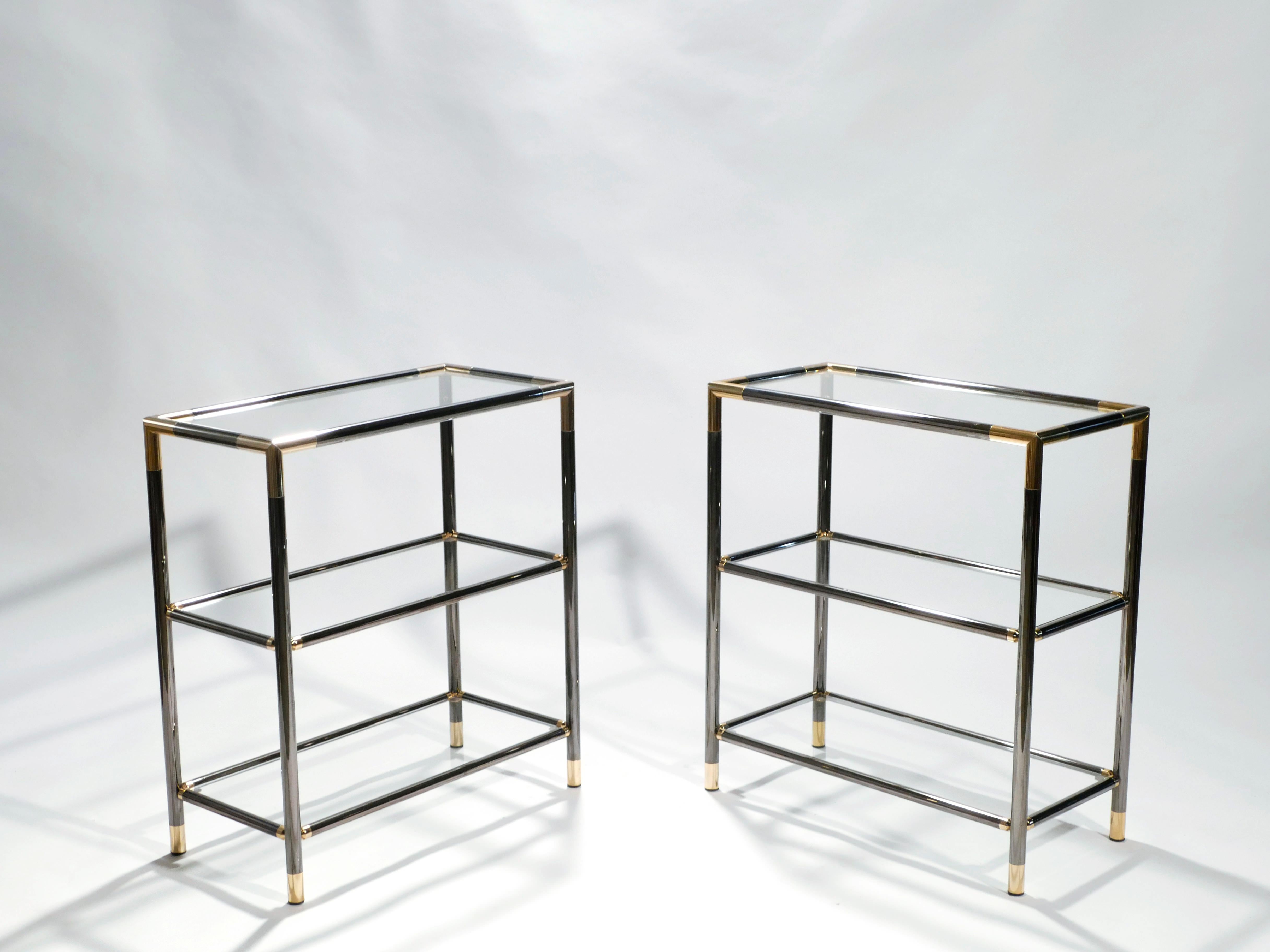 The designer of this pair of gunmetal and brass three-tiered shelves aimed to emulate the simple structure and visual drama of Maison Jansen’s iconic style. Sleek lines and an ordinary rectangular structure are offset by bright brass joints at all