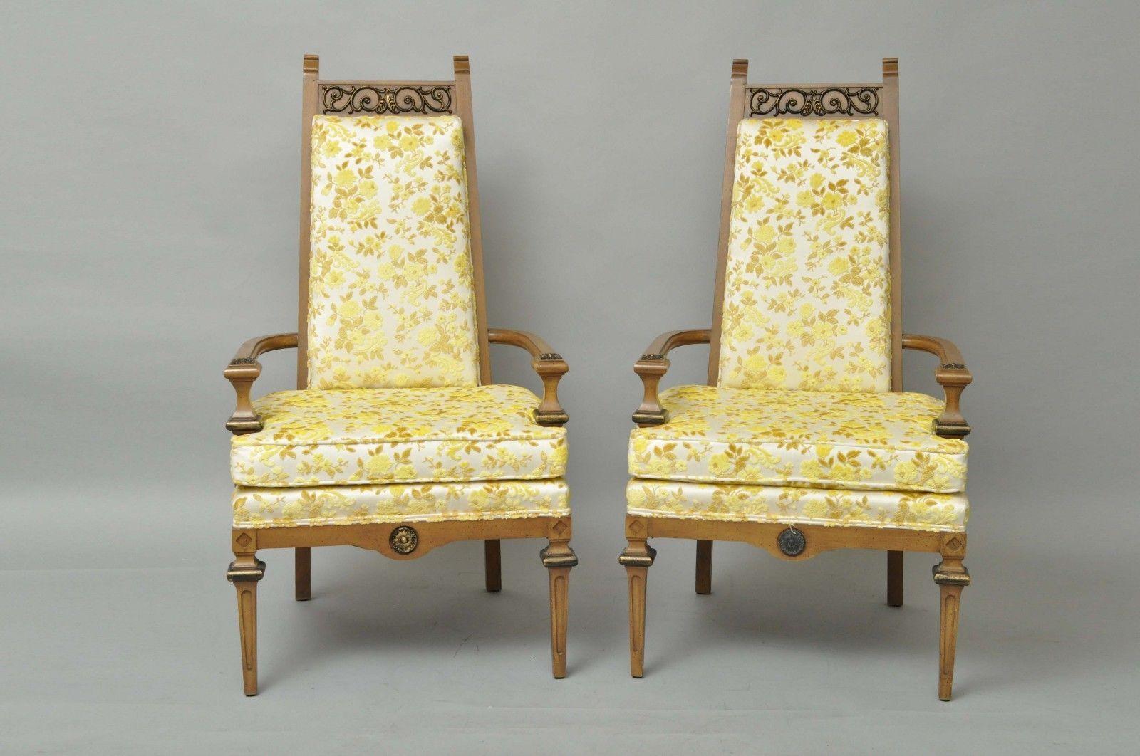 Pair of vintage Hollywood Regency high back armchairs. Item features stately solid wood frames, scrolling brass ormolu, clean lines, white and gold floral upholstery, circa mid-20th century, American. Measurements: 48.5