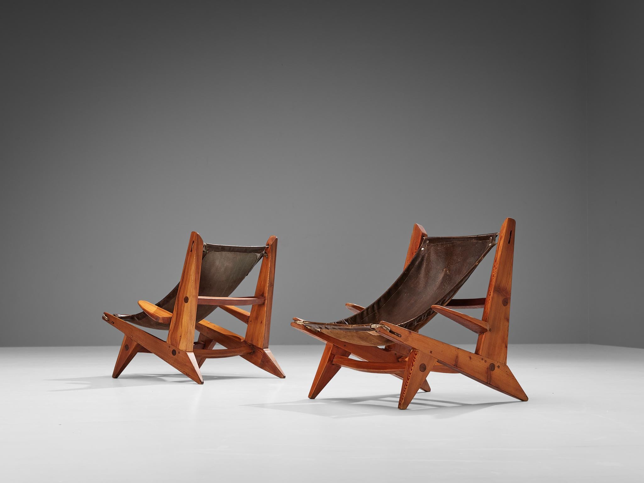 Pair of hunting chairs, leather, pine, France, 1950s

This pair of hunting chairs features wonderful patinated brown leather on both seat and back. The chairs are sculpturally built with a chunky touch. The pine wood is a natural grained, strong and