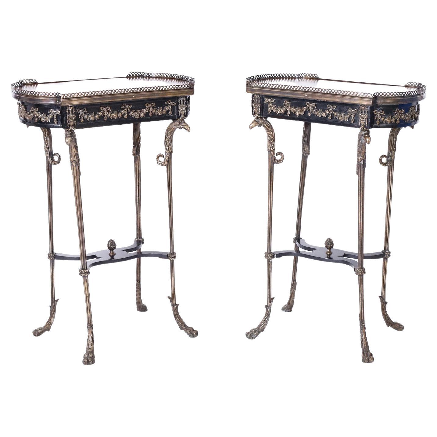 Rare and remarkable 19th century French stands with classical inlaid designs in mahogany, walnut, satinwood, and kingwood on the tops, with brass galleries over an ebonized case with ormolu. The brass bases have bird heads on long elegant legs