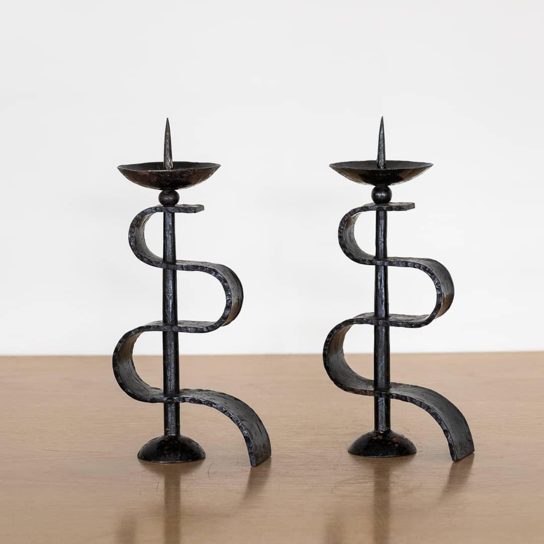 Pair of black iron candlesticks from France, 1950's. Beautiful squiggle iron detail on stem. Painted black iron shows great age and patina. 