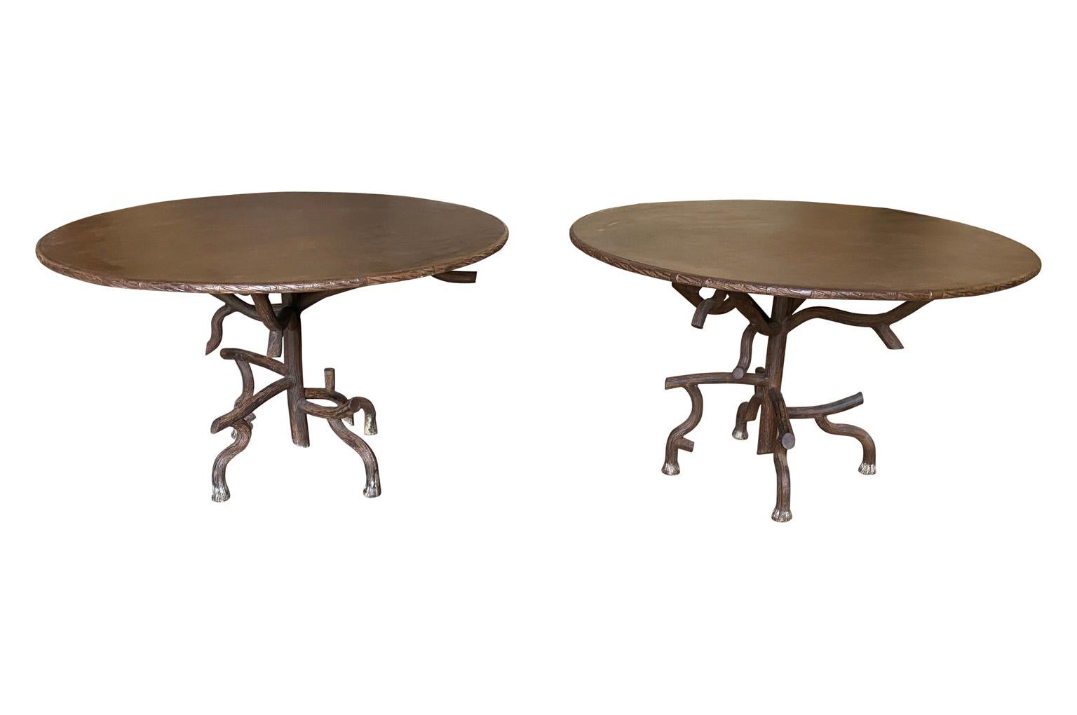 A sensational pair of garden dining tables from the Provence region of France. These tremendous tables are hand crafted by an artist blacksmith in beautifully patina'd iron in the Faux Bois theme. Fabulous detailing to the table tops' edges and