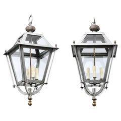 Pair of French Iron Four-Light Lanterns with Glass Panels and Scrolling Accents