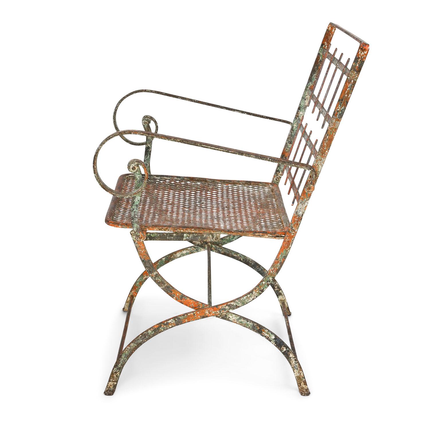 Pair of French iron garden chairs with traces of original paint, circa 1910. Chairs are sold together as a pair for $3,200.