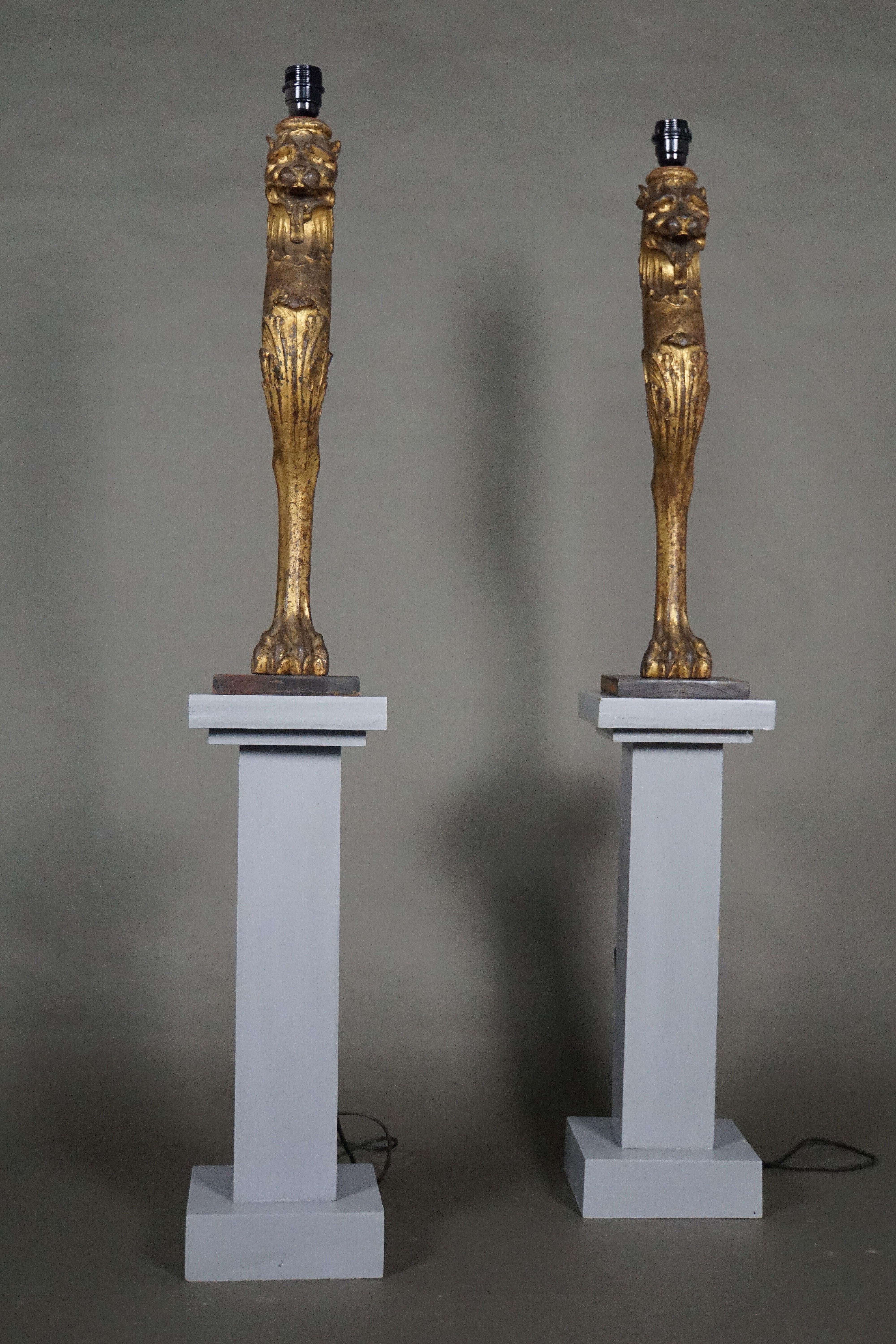 This pair of iron cast and gilded lamps on iron stand in the form of chimerics, without screen, without pedestal. France. First half of the 19th century.
 