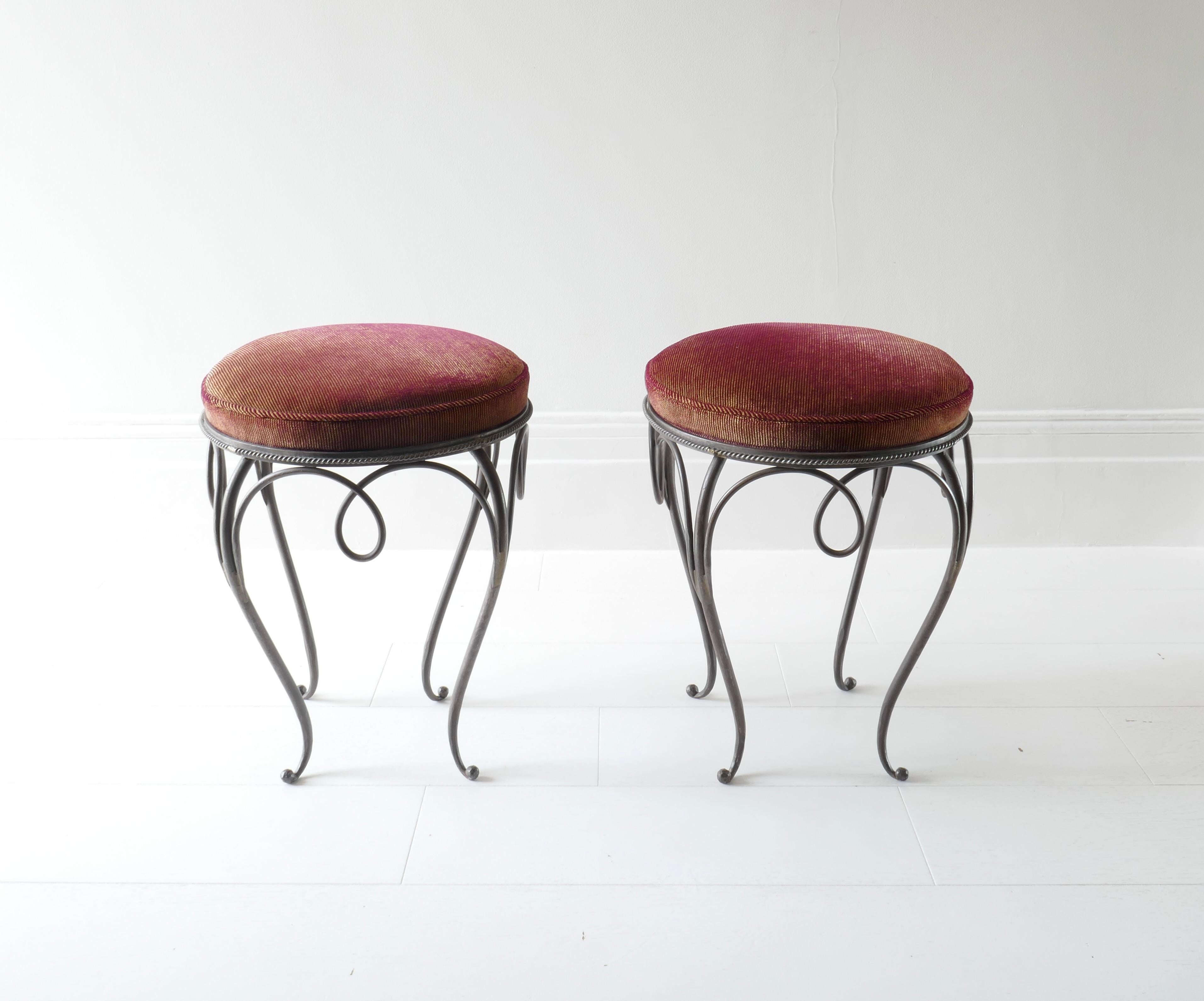 Pair of round iron stools in the style of René Drouet and René Prou. The iron base features cabriole legs. The seats have been reupholstered in a delicate striped burgundy and green velvet.
Perfect under a small table or vanity unit.
Seat height