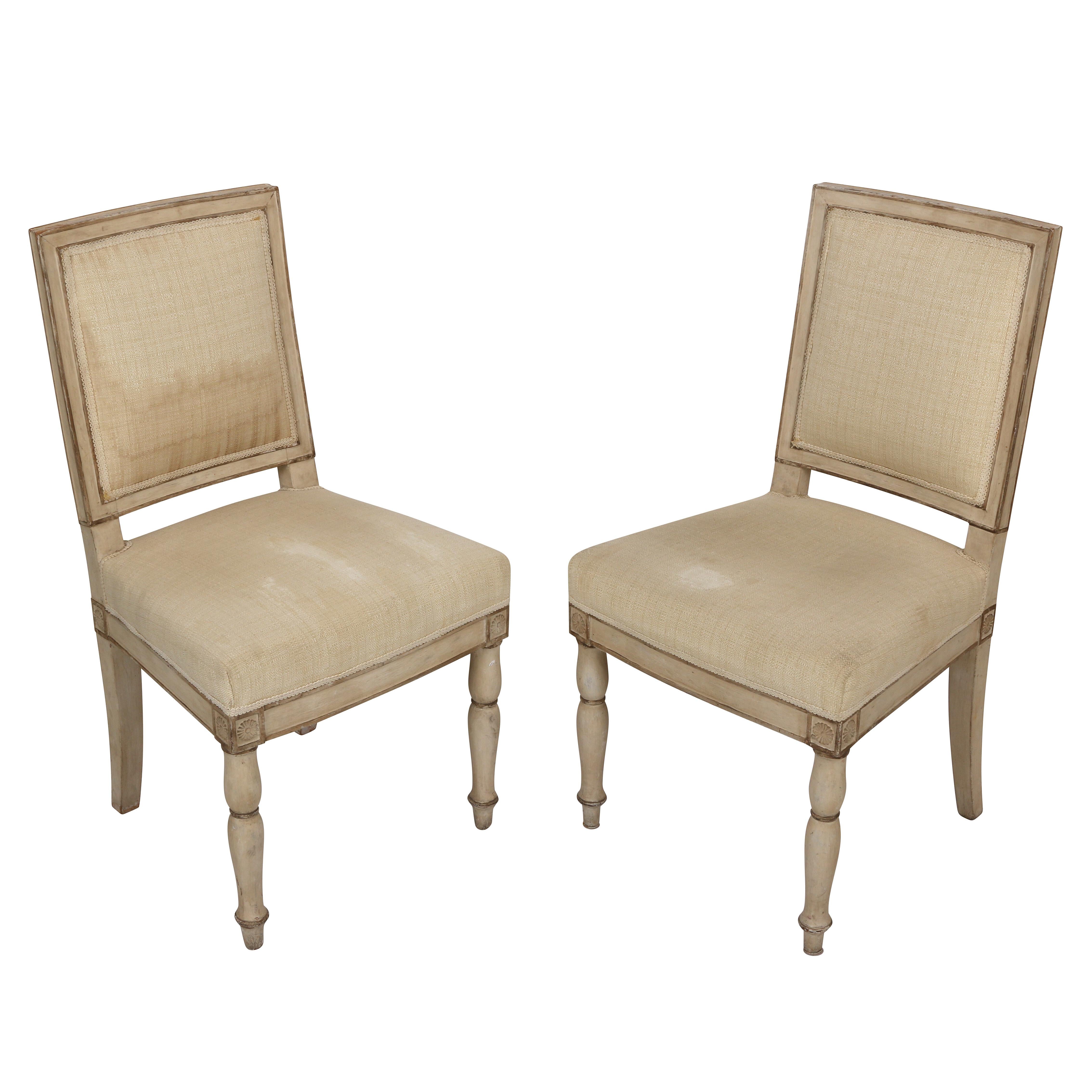 A lovely pair of vintage French wood painted chairs with ivory upholstered seat and back. This super chic pair has a delicate presence and is an adorable addition to either side of a console table or seating area in your home!