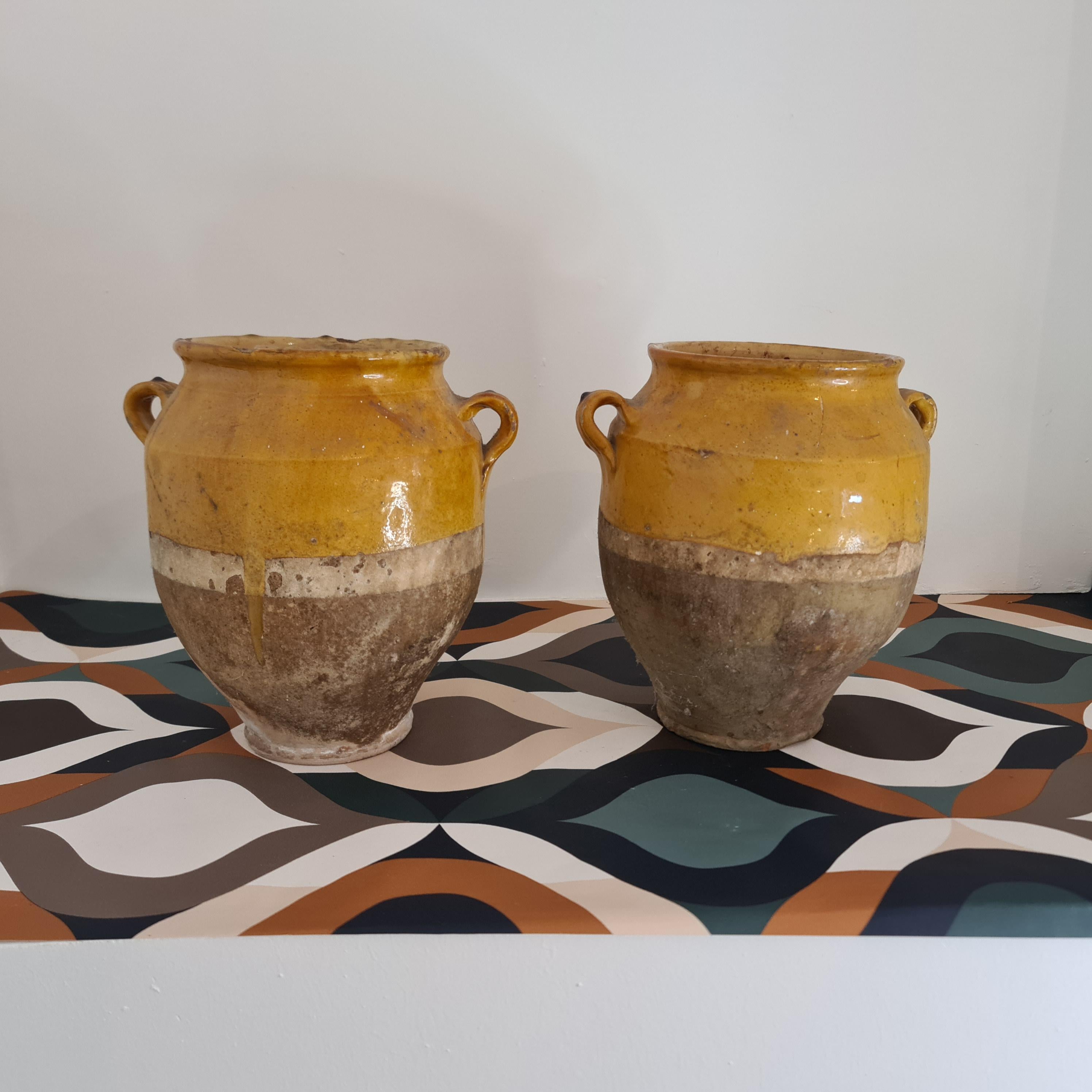 pair of French jars from the 19th century. Provencal glazed pottery with 2 handles, some lacks in the glaze consistent with age and use
In southern France in the mid 19th century these mustard-coloured pottery vessels were used to store meat
These
