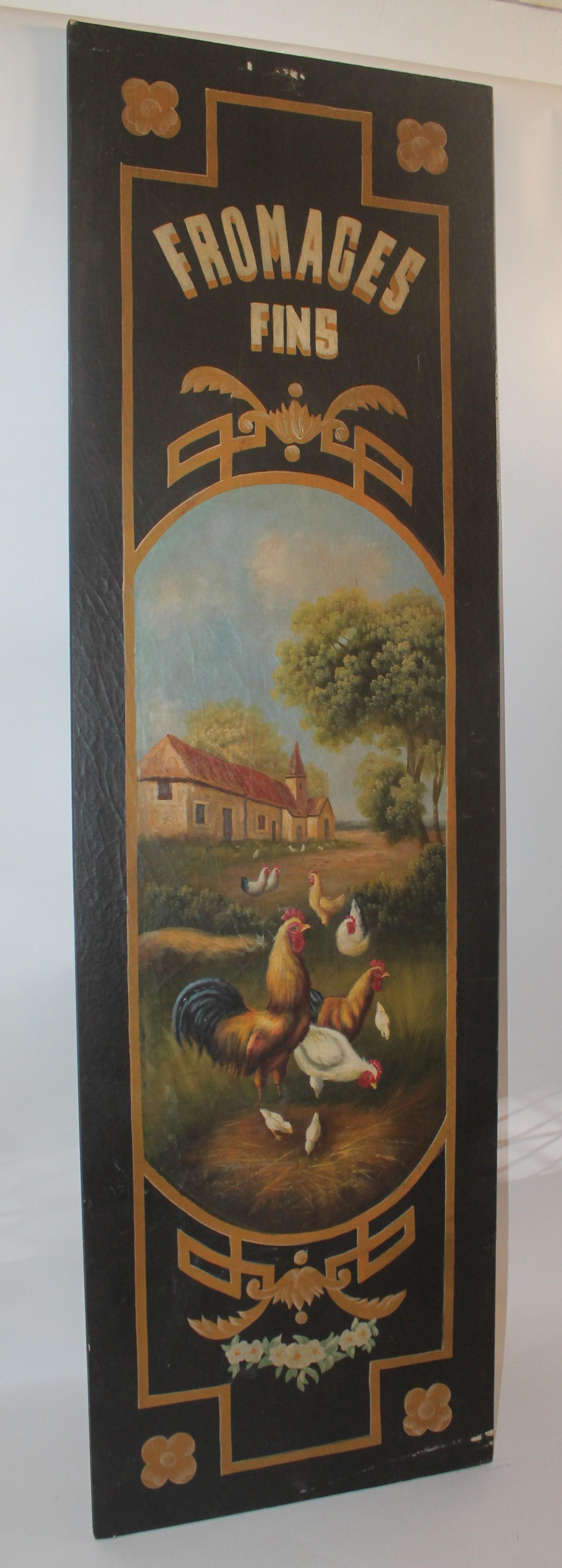 This pair of original hand painted French painted cafe signs or pantry signs are copies of 19th century boards from the 1930s. The condition is very good with minor scars or chips in the canvas. The surface is a crackle finish. Assorted cheeses and