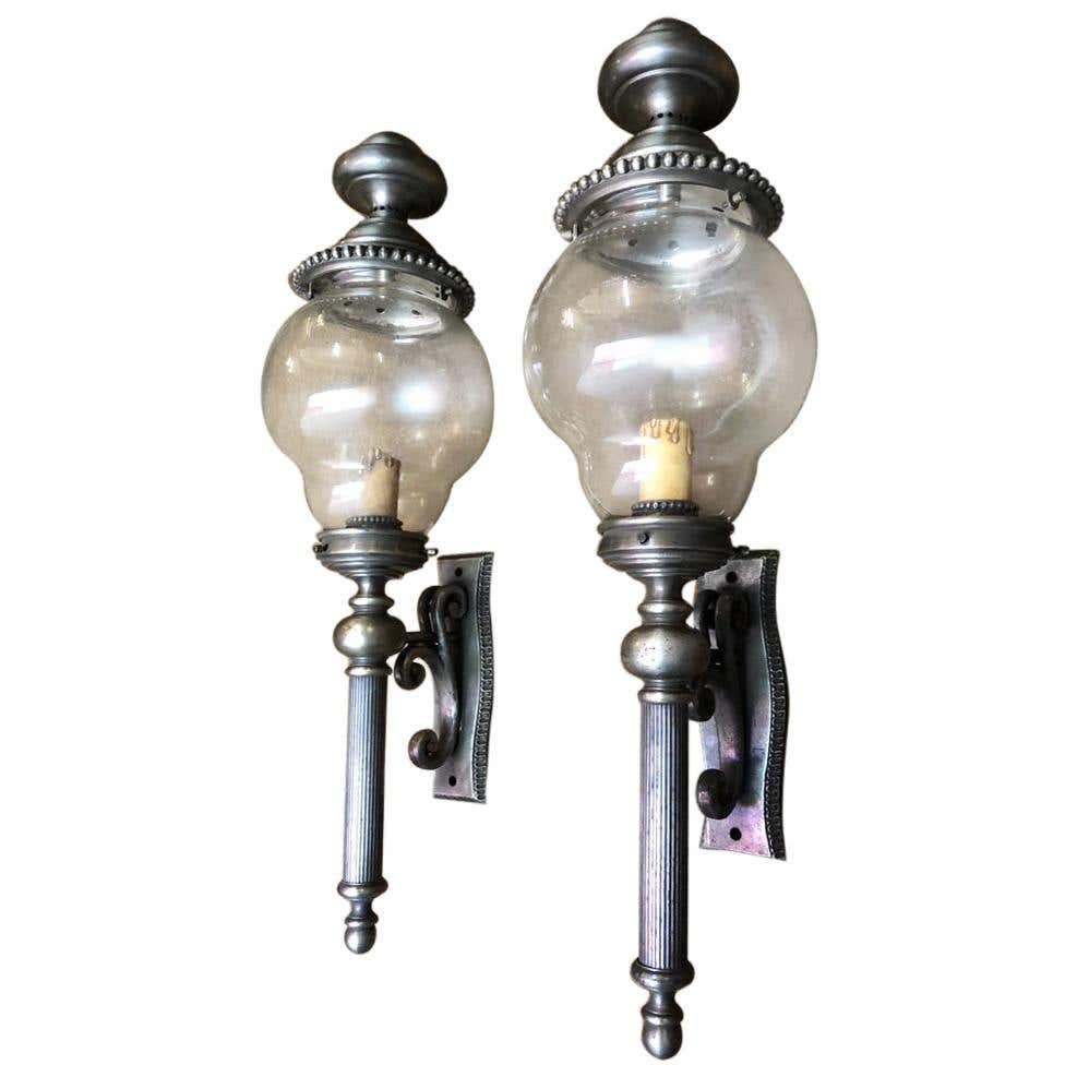 A gorgeous pair of lanterns, nickel-plated, 20th century. This fine pair have globe glass boles and are over 2 feet tall.
