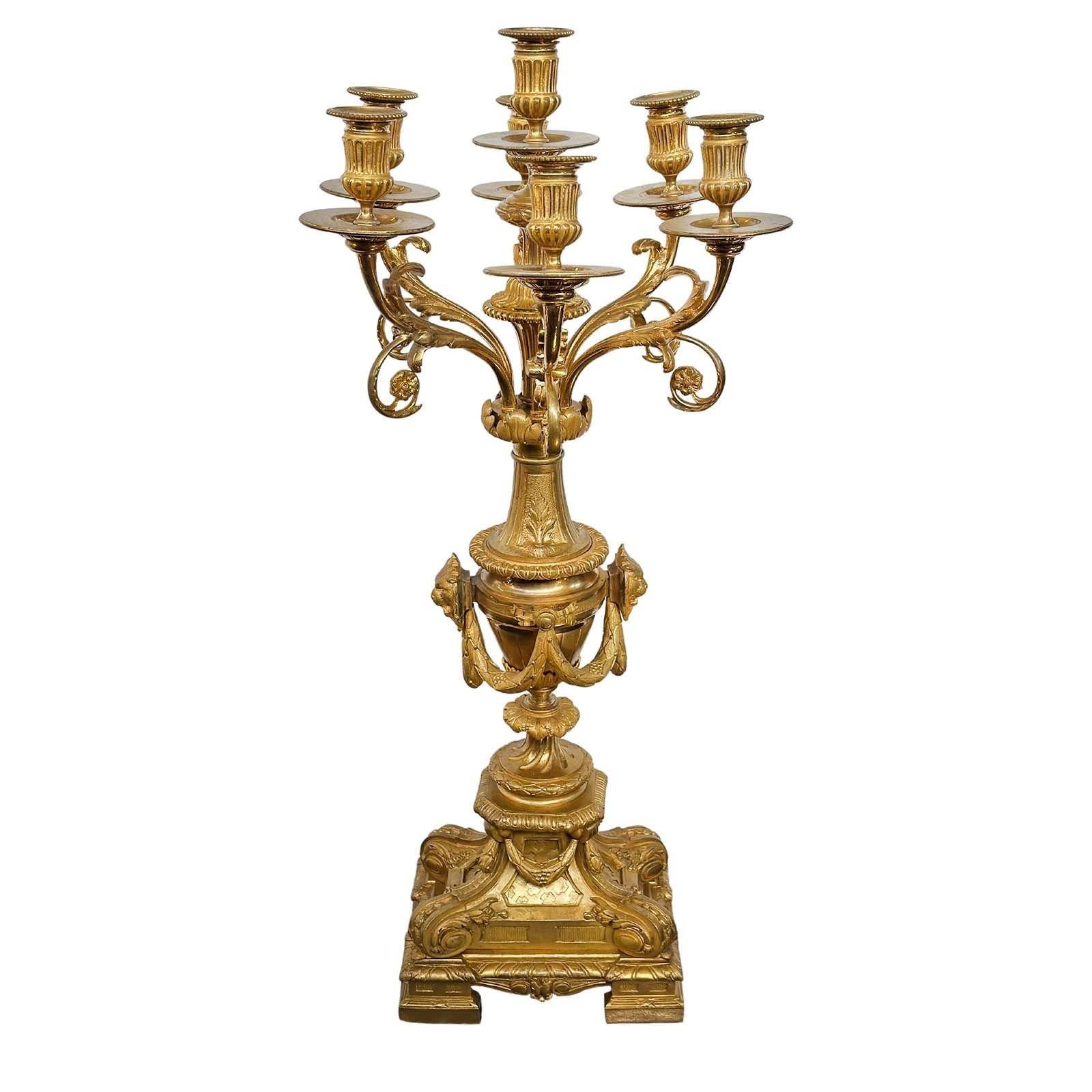 Pair of graceful gold-plated bronze D'ore candelabras. Made in France in the late 19th century. 
These candelabras boast a delightful combination of bronze and gold plating, lending a touch of timeless sophistication to any space. The intricate