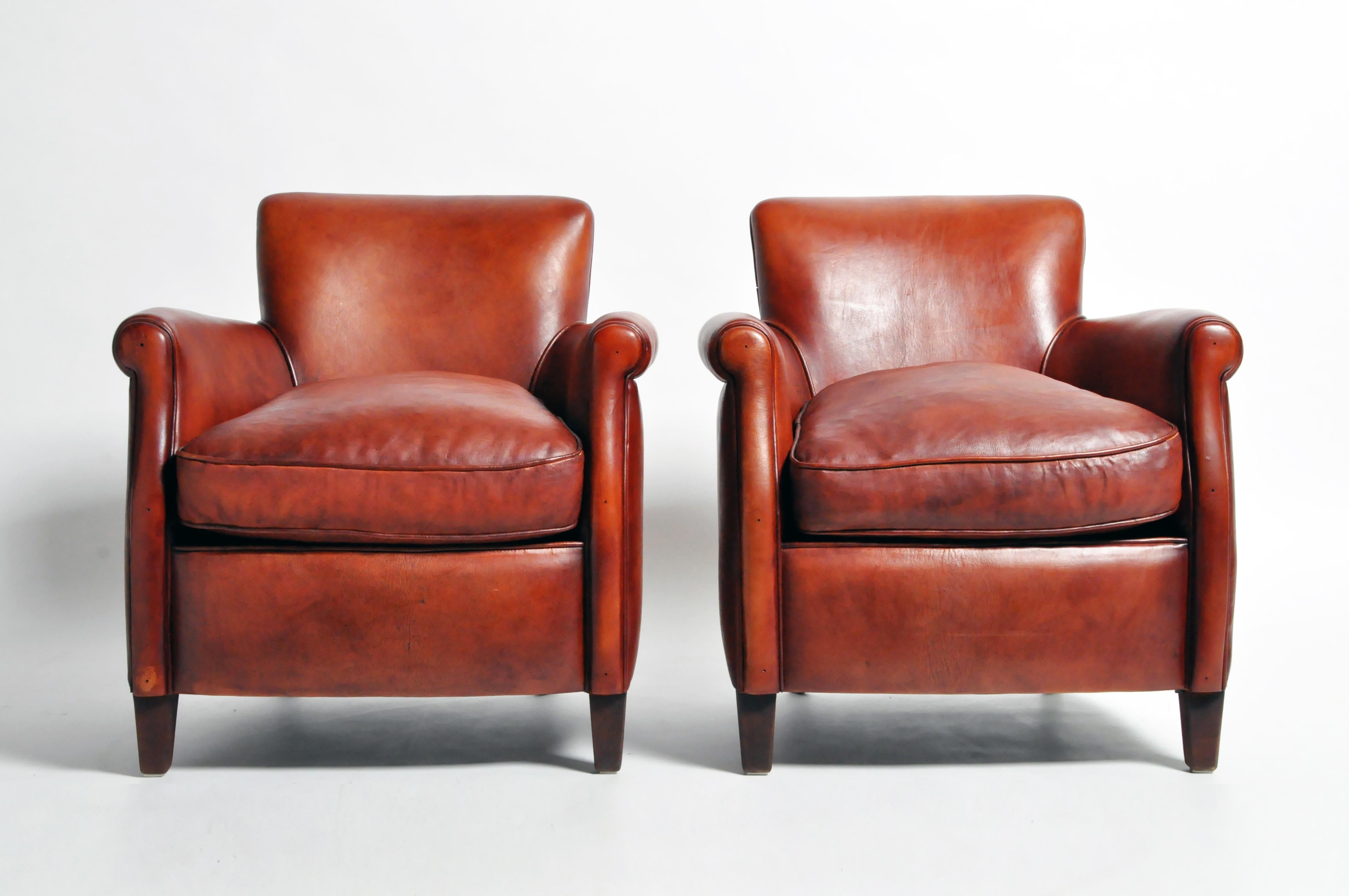 This pair of armchairs are from France and made from leather and wood, circa 21st century. They are newly made and feature a beautiful oxblood brown color; sturdy, comfortable, and ready for daily use.