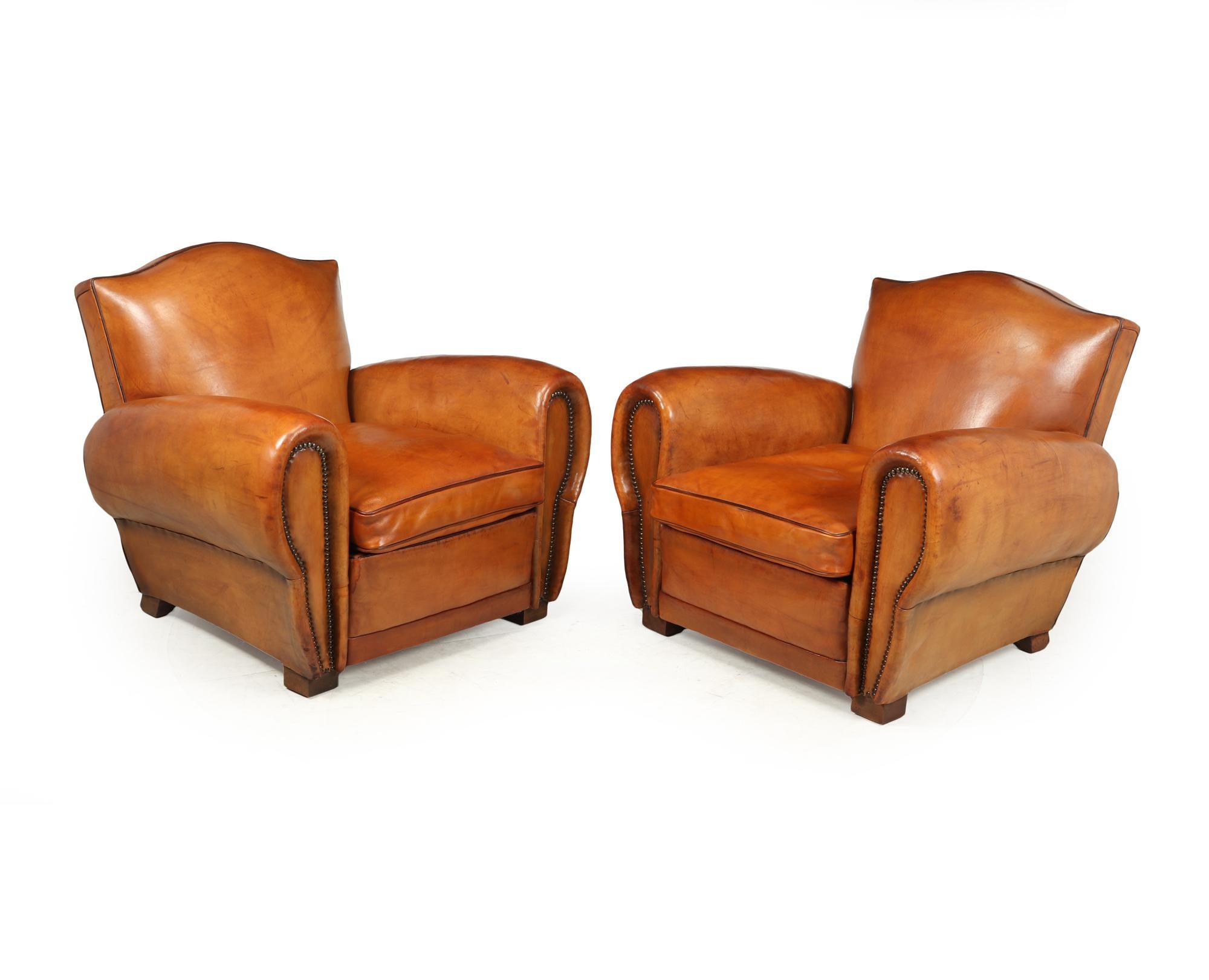 An exceptional example of a pair of French leather club chairs that rare to find in caramel tan coloured very thick leather with camel backs and contrasting piping, these chairs look to me that they were expertly re-upholstered around 30 years ago