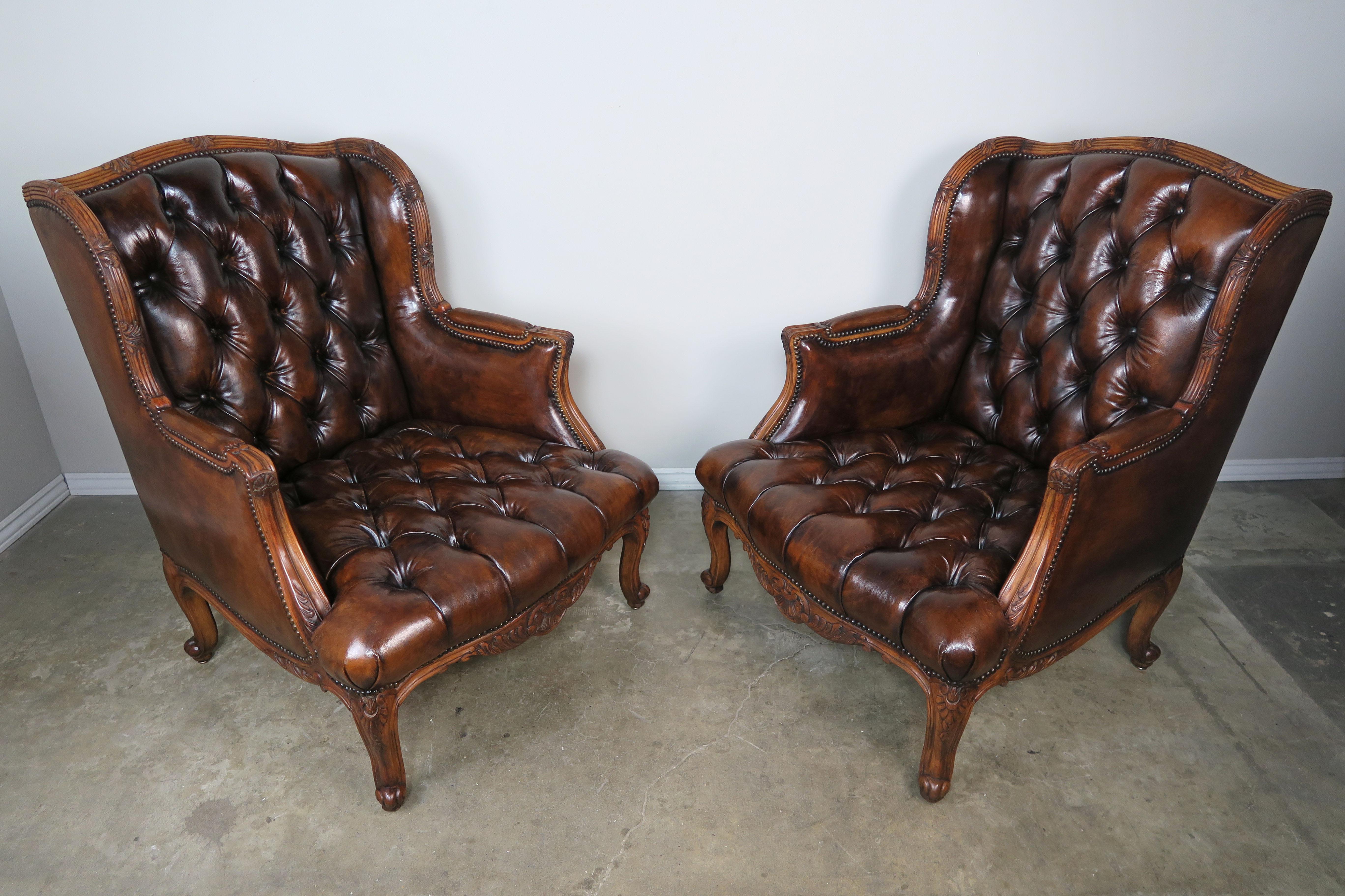 Brass Pair of French Leather Tufted Armchairs with Matching Ottomans