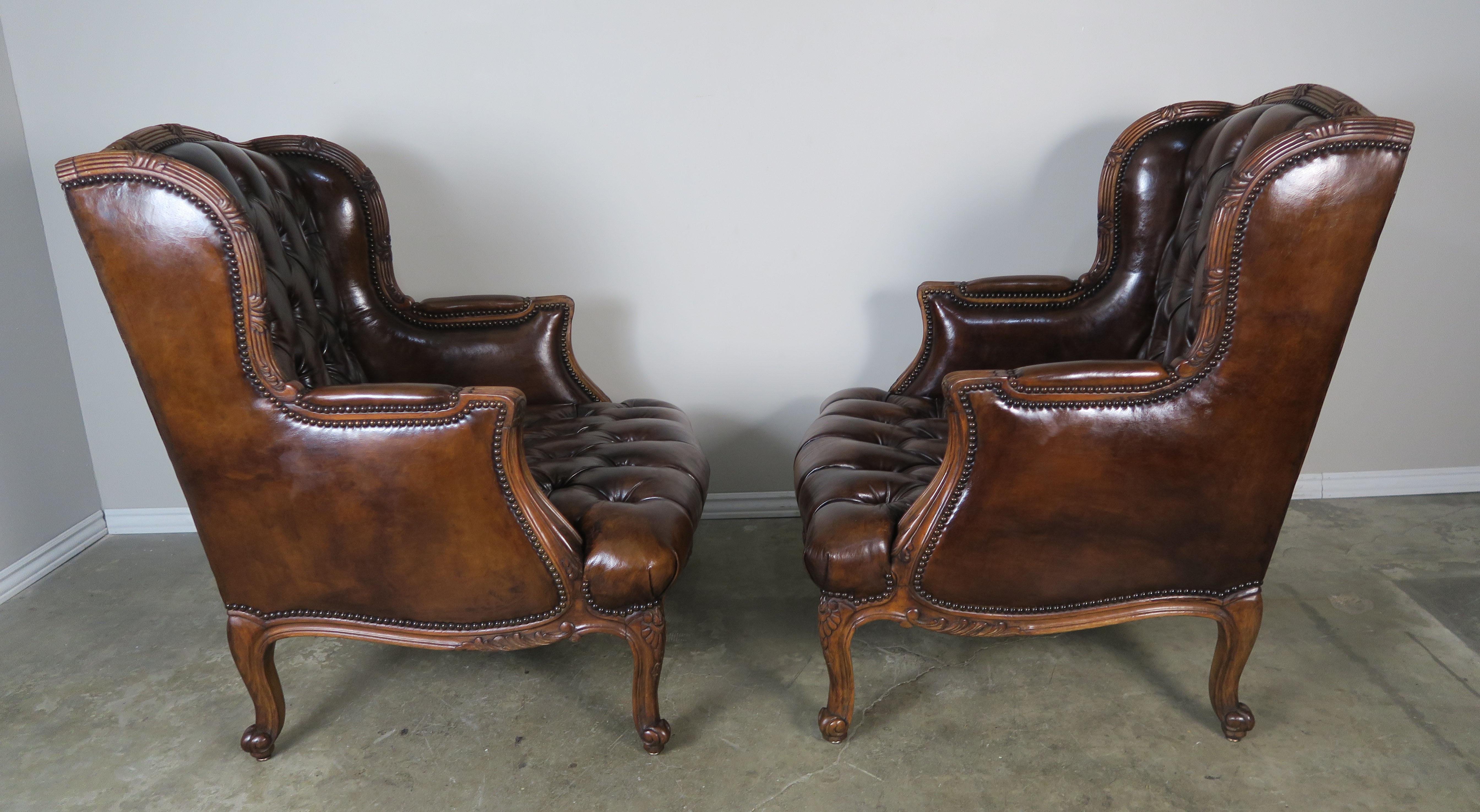 Pair of French Leather Tufted Armchairs with Matching Ottomans 1