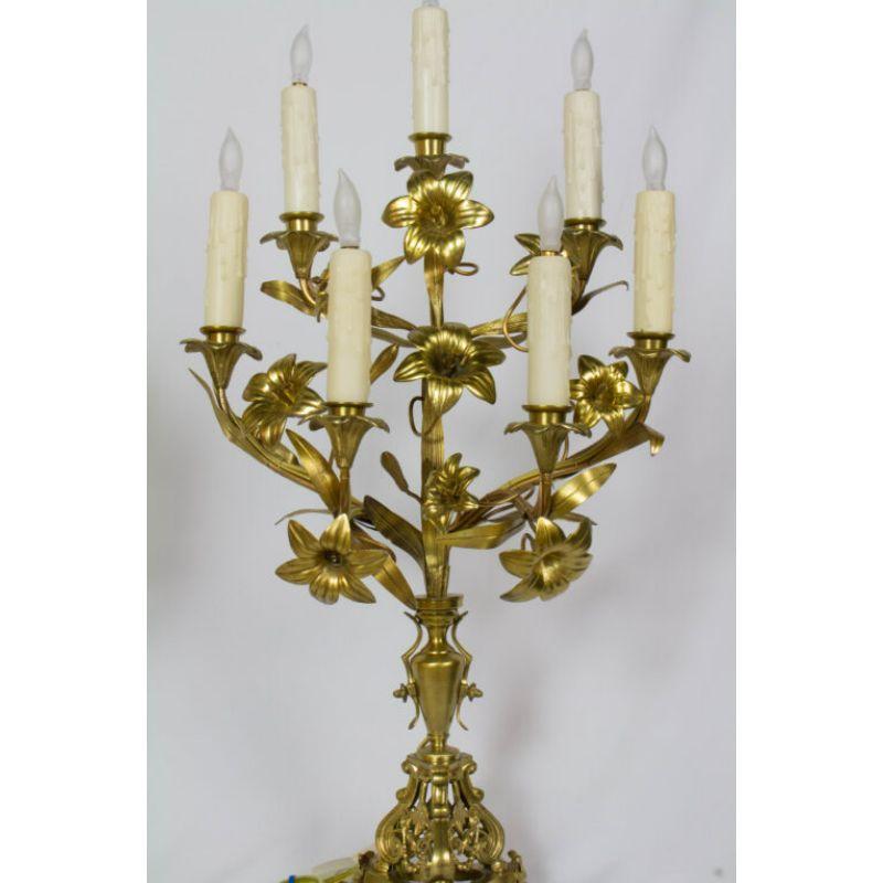 Pair of French Lily Candelabra with seven lights. Completely restored and wired. Originally Candle. Gilded bronze with a marble base. French. 19th Century, Napoleon III. 

Dimensions: 
Height: 28?
Width: 16?
Depth: 8?.