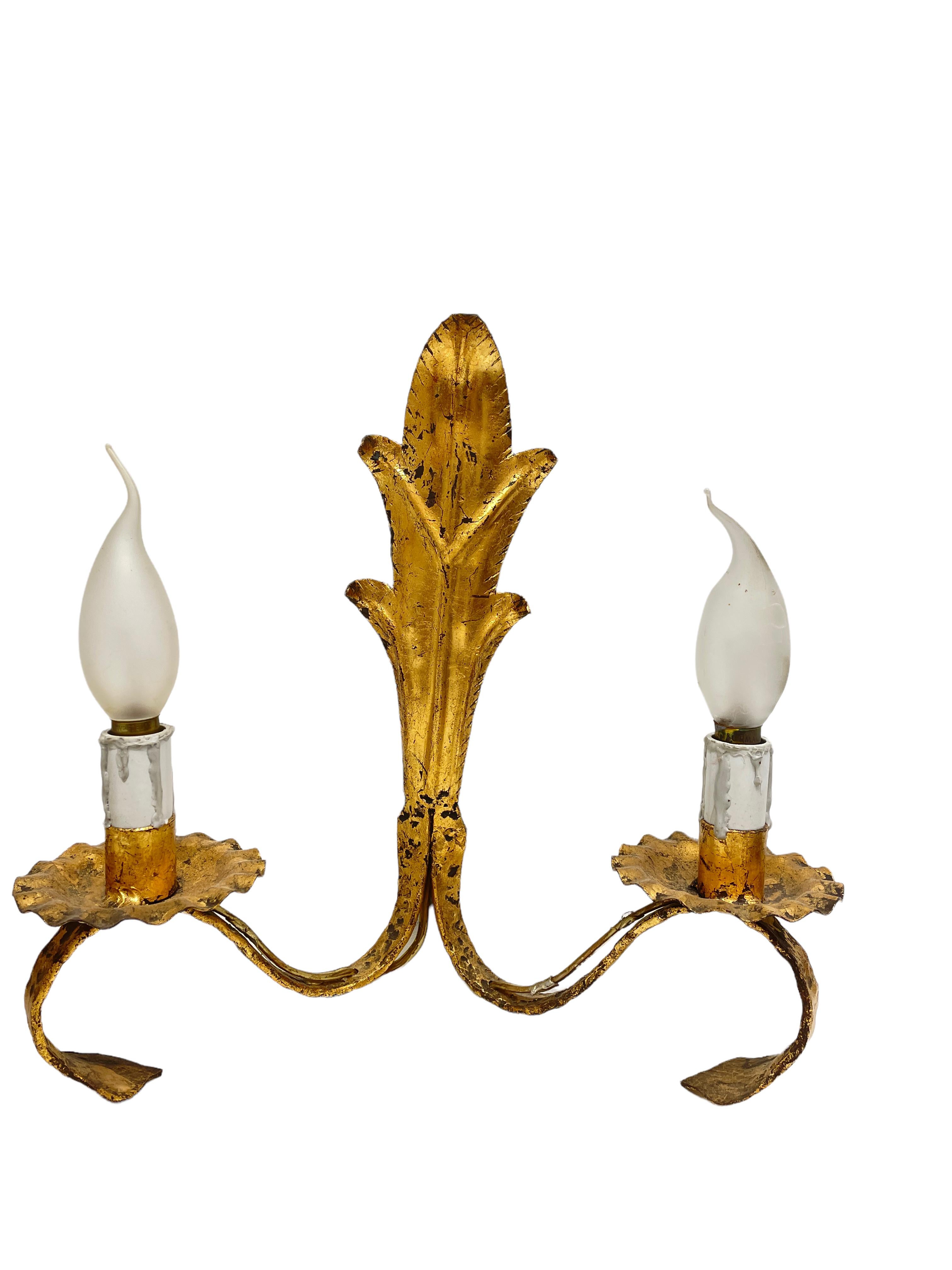 A pair Hollywood Regency midcentury gilt floral tole sconces, each Fixture requires two European E14 / 110 Volt Candelabra bulbs, each bulb up to 40 watts. The wall lights have a beautiful patina and give each room an eclectic statement. Lightbulbs